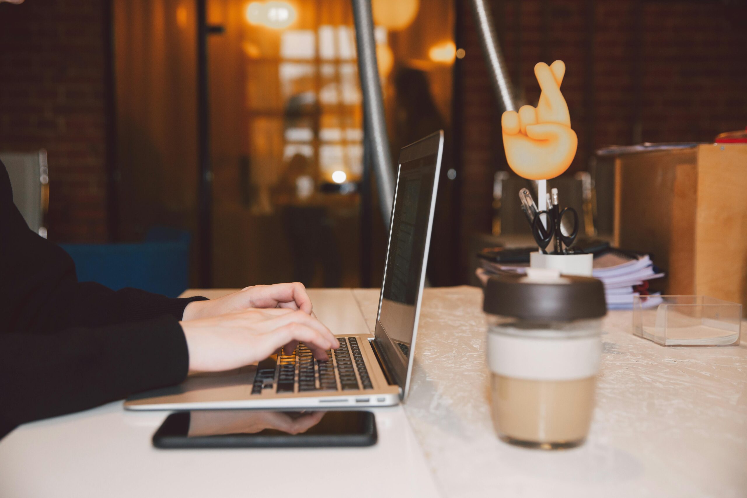 Person typing on a laptop while searching virtual assistant job listings.