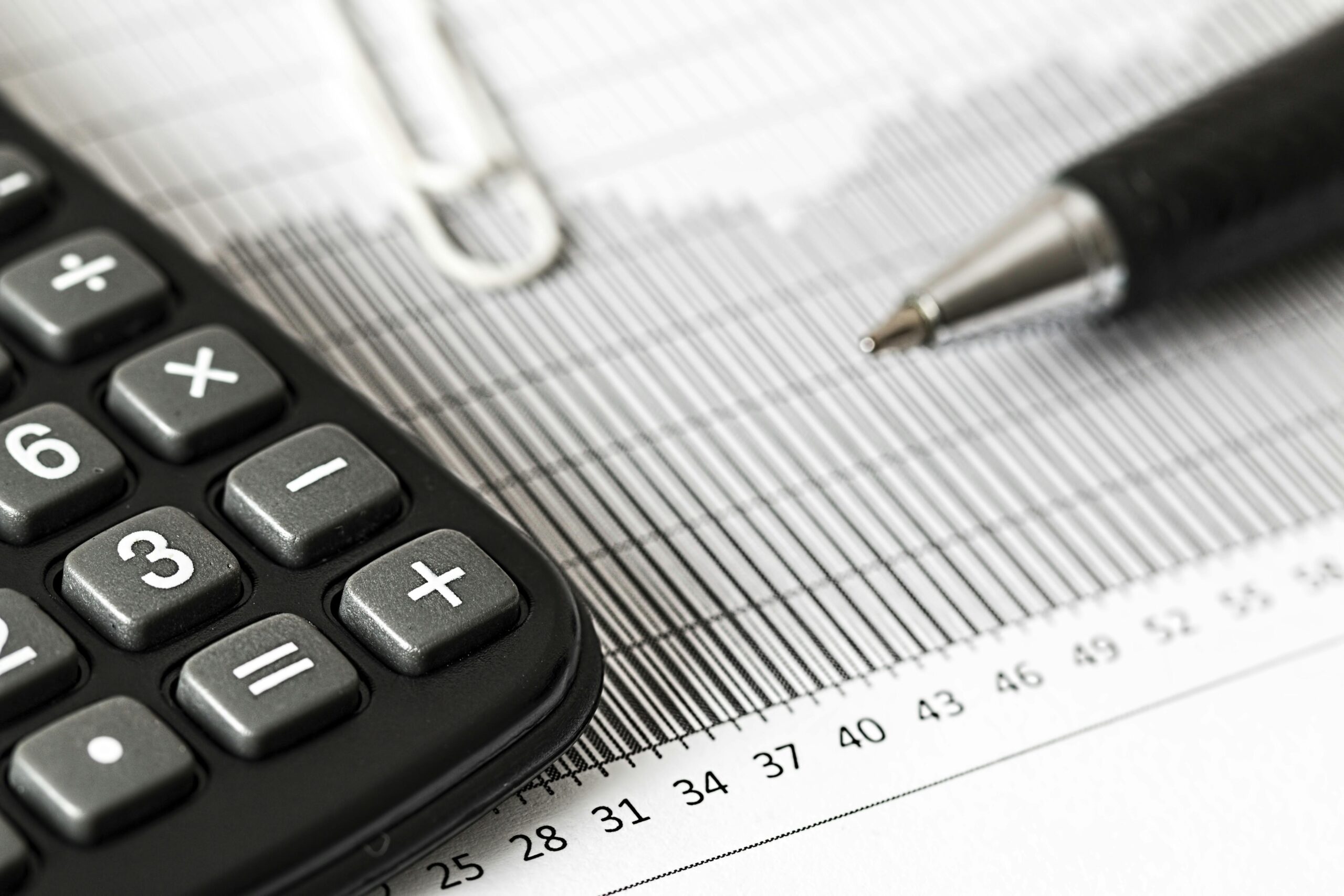 A calculator and pen on financial documents.