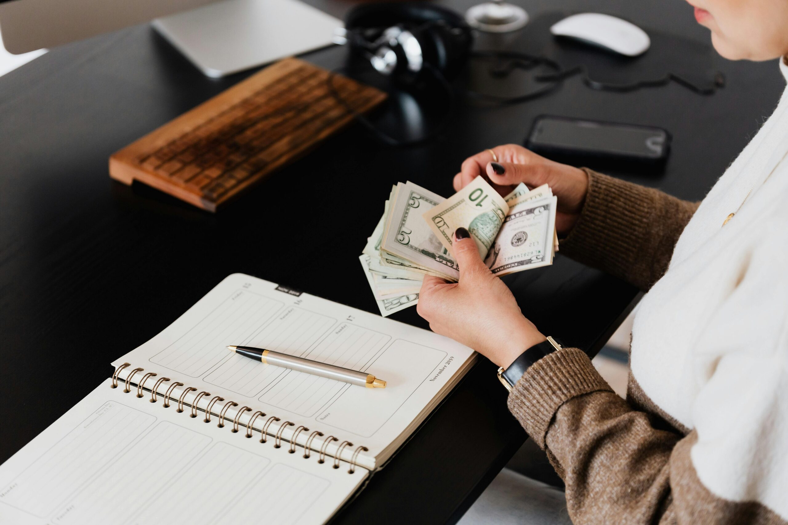 Person counting money as part of accounting outsourced services