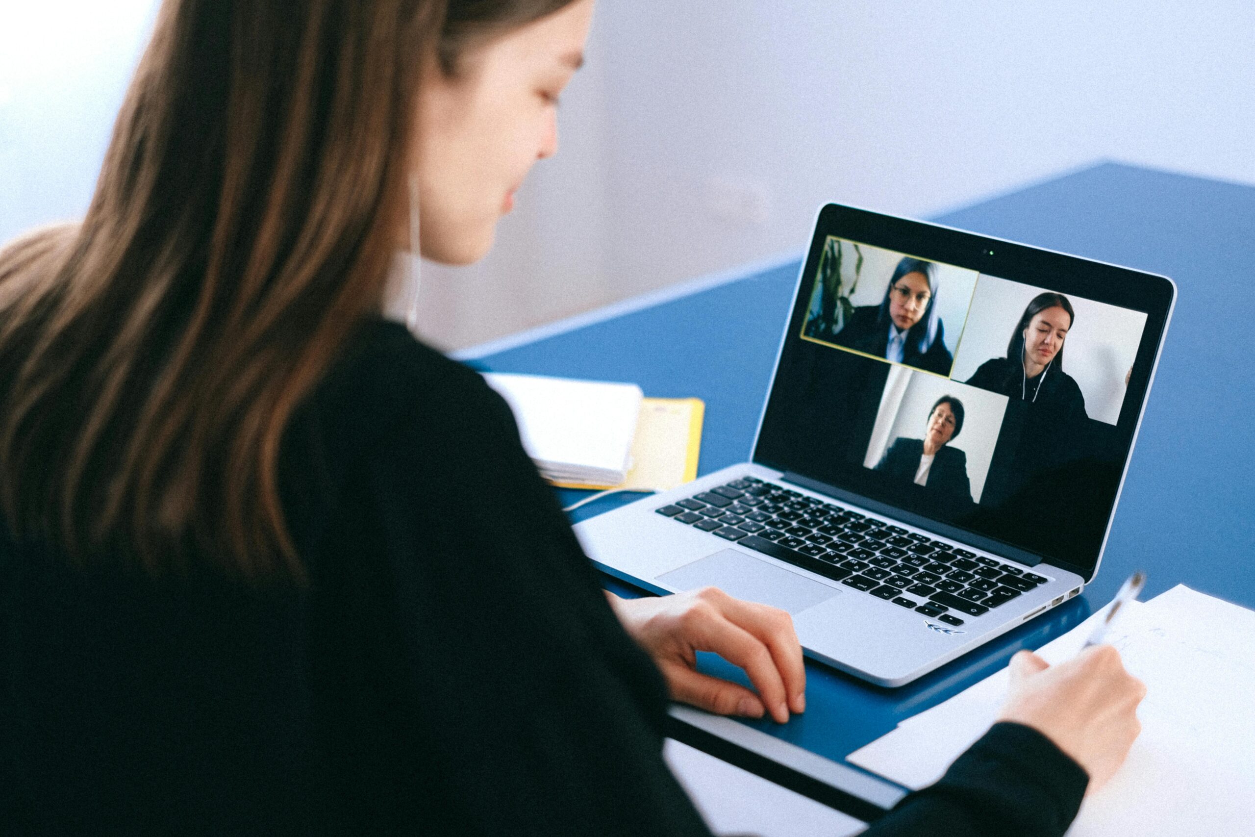 Team conducting a video conference to hire overseas employees.