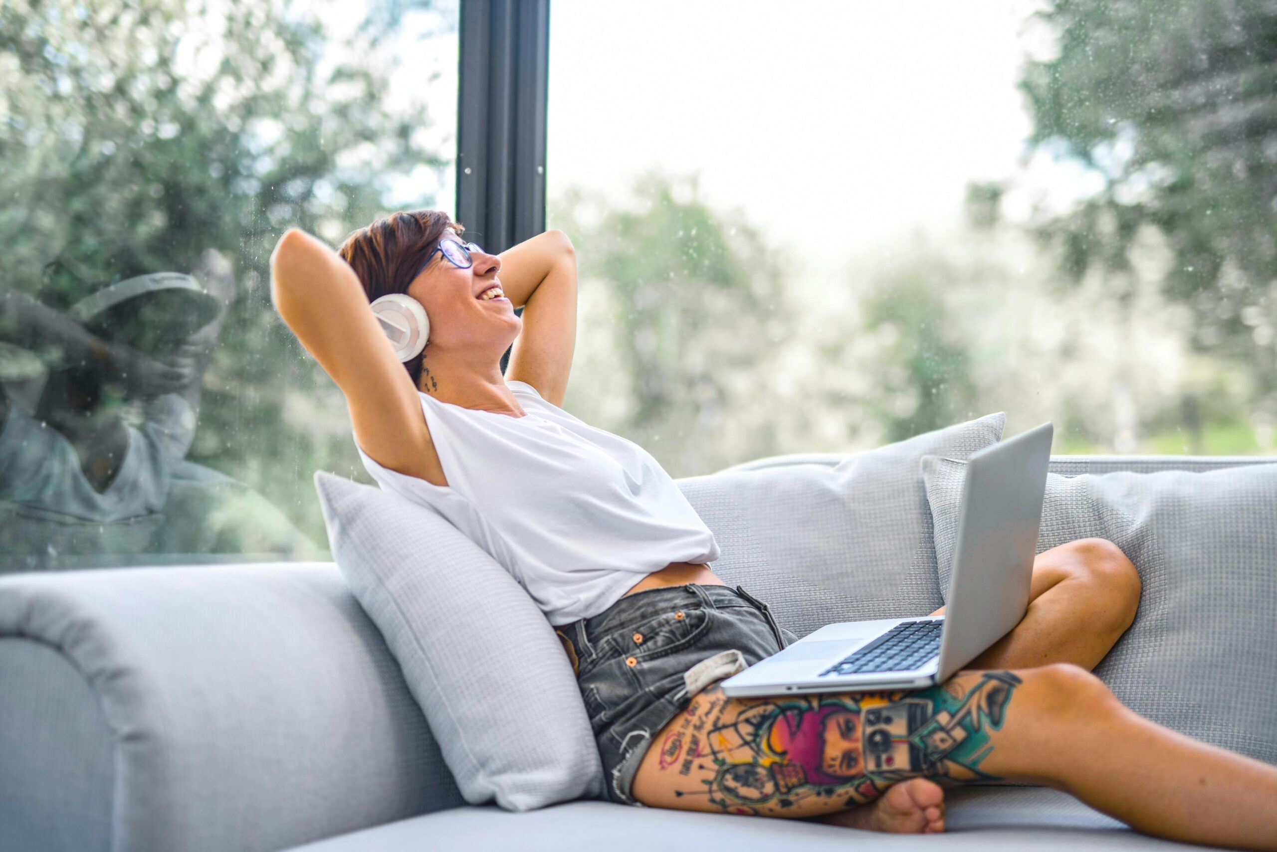 Woman using tablet and laptop for remote work events