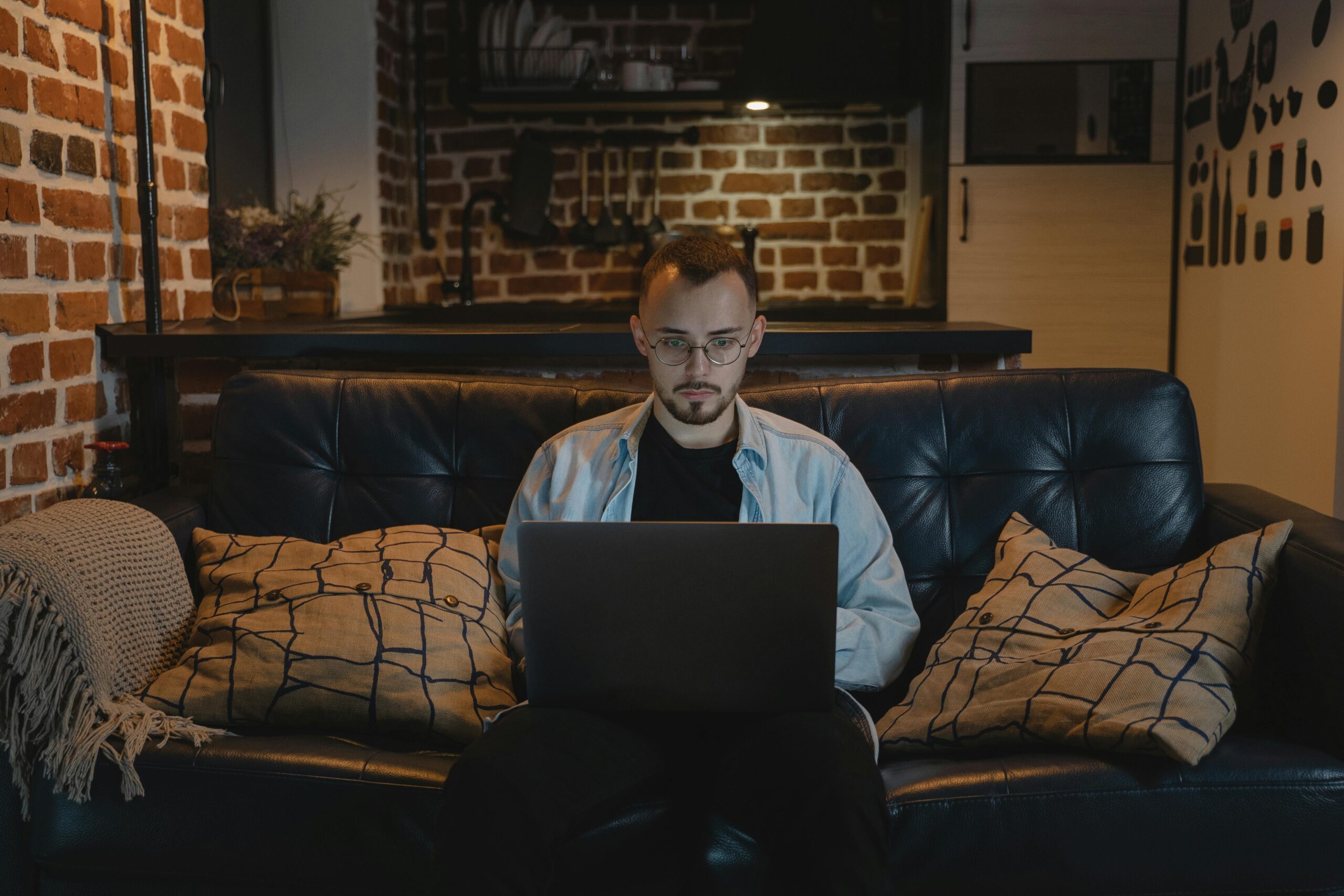 Man working on laptop during remote work events.
