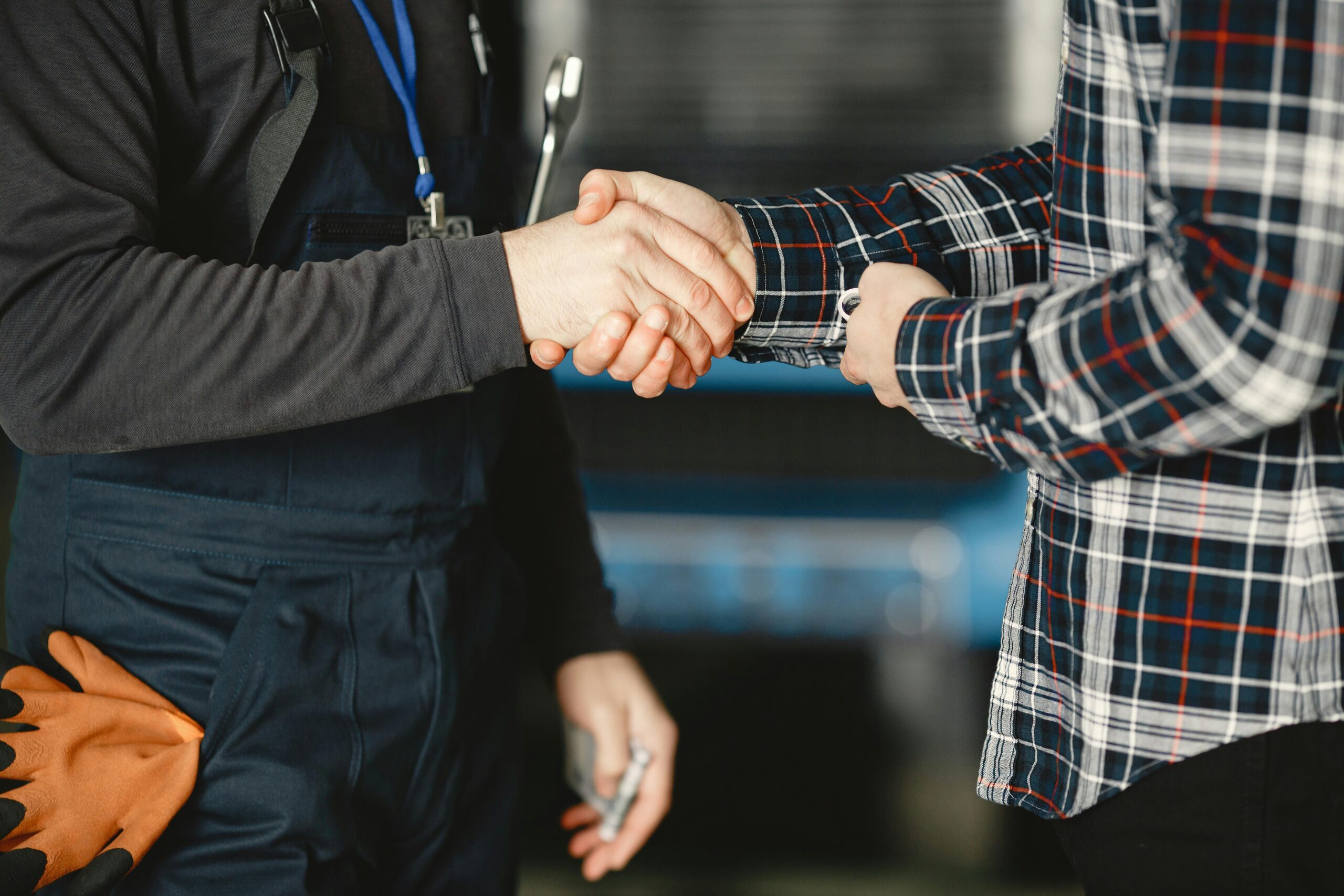 Two people shaking hands in a professional setting, representing a successful interaction by a sales closer.
