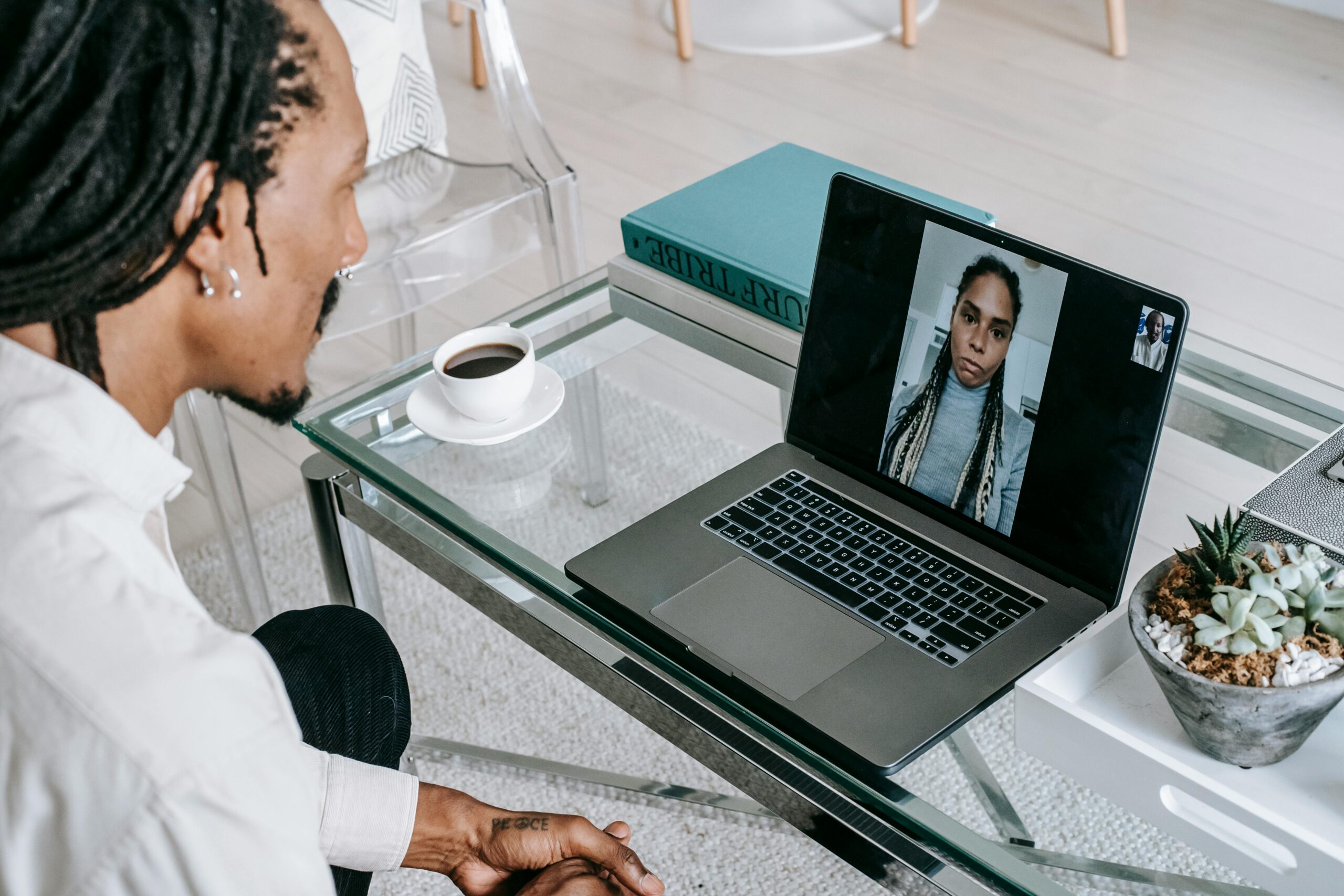 Man on a video call with a colleague, demonstrating remote marketing team communication.