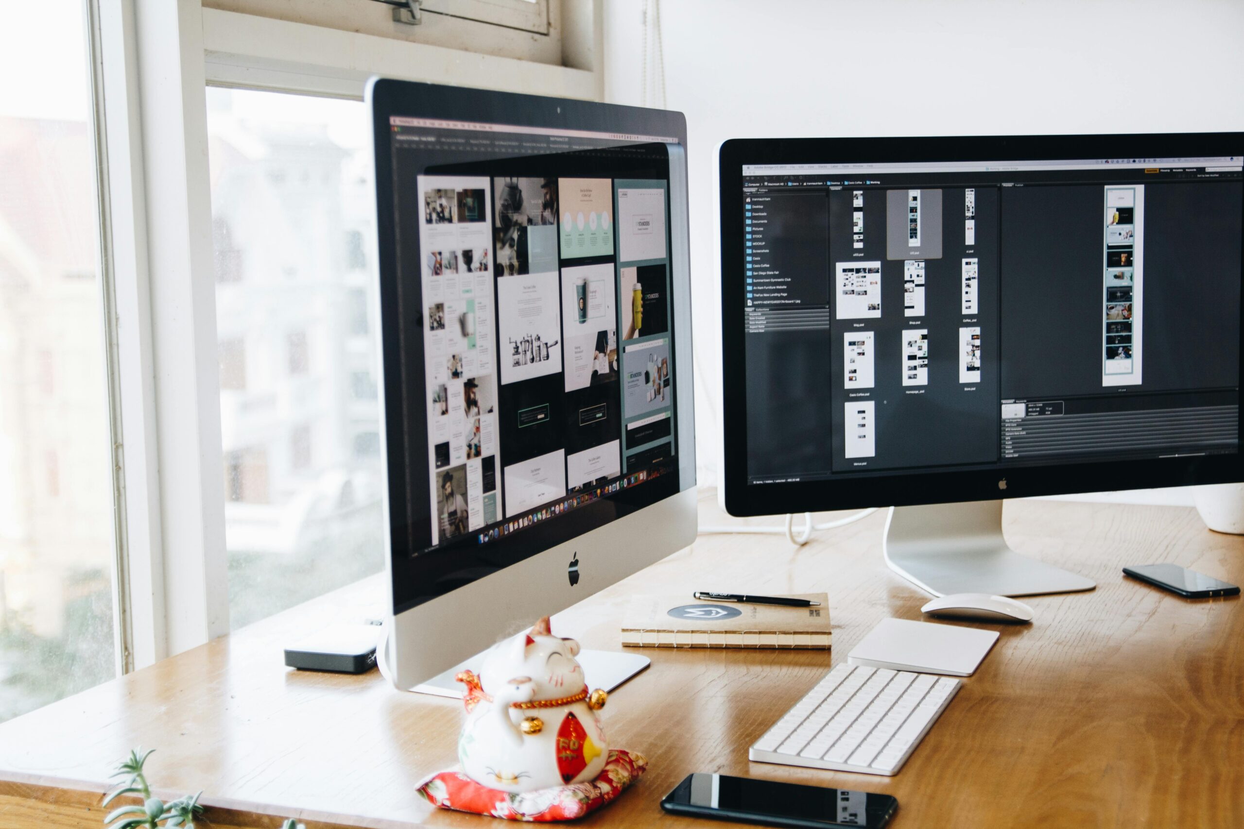 Dual monitor setup with design projects.
