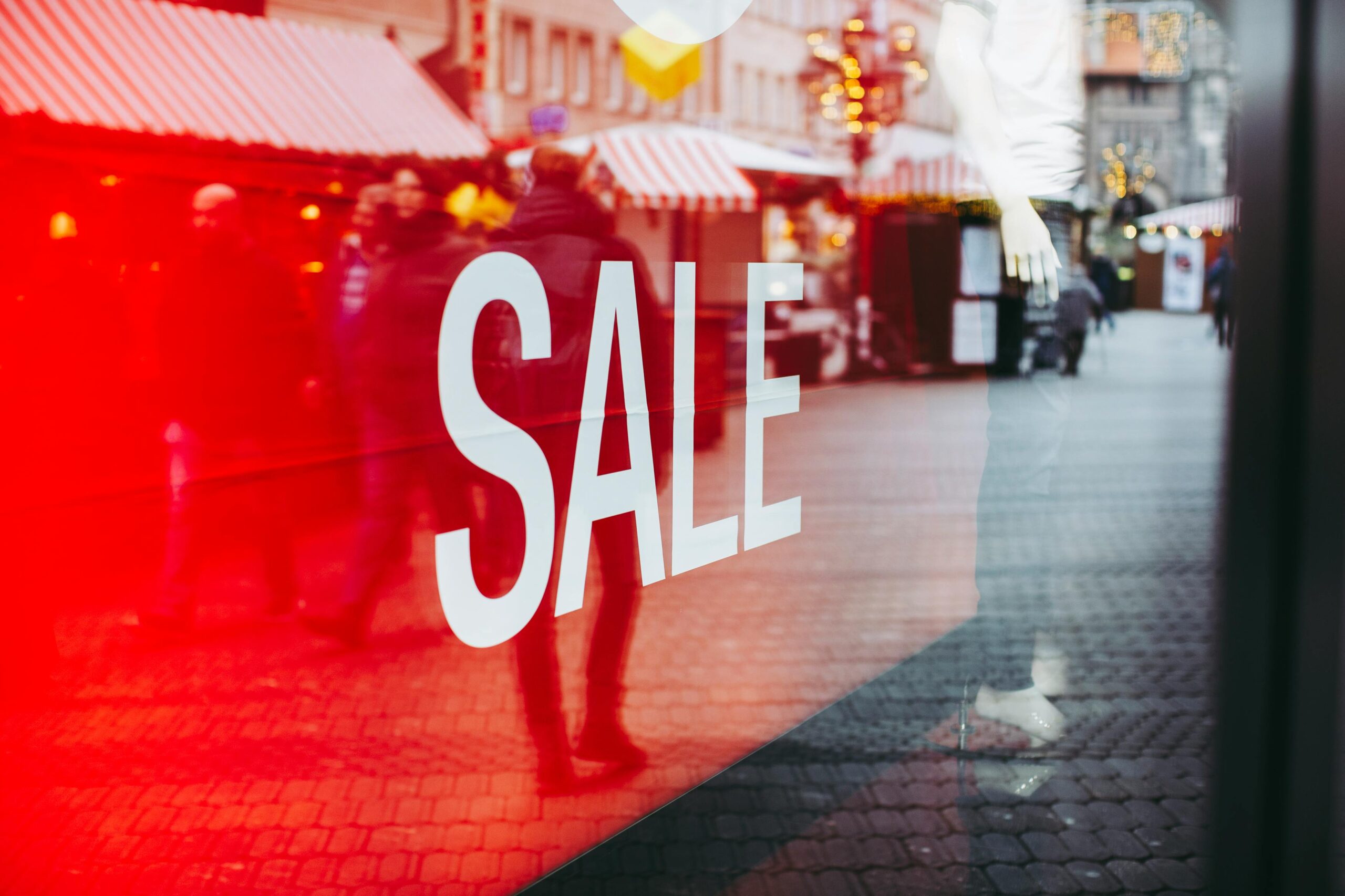 Sale sign in a store window, highlighting the promotion element of the marketing 4Ps.
