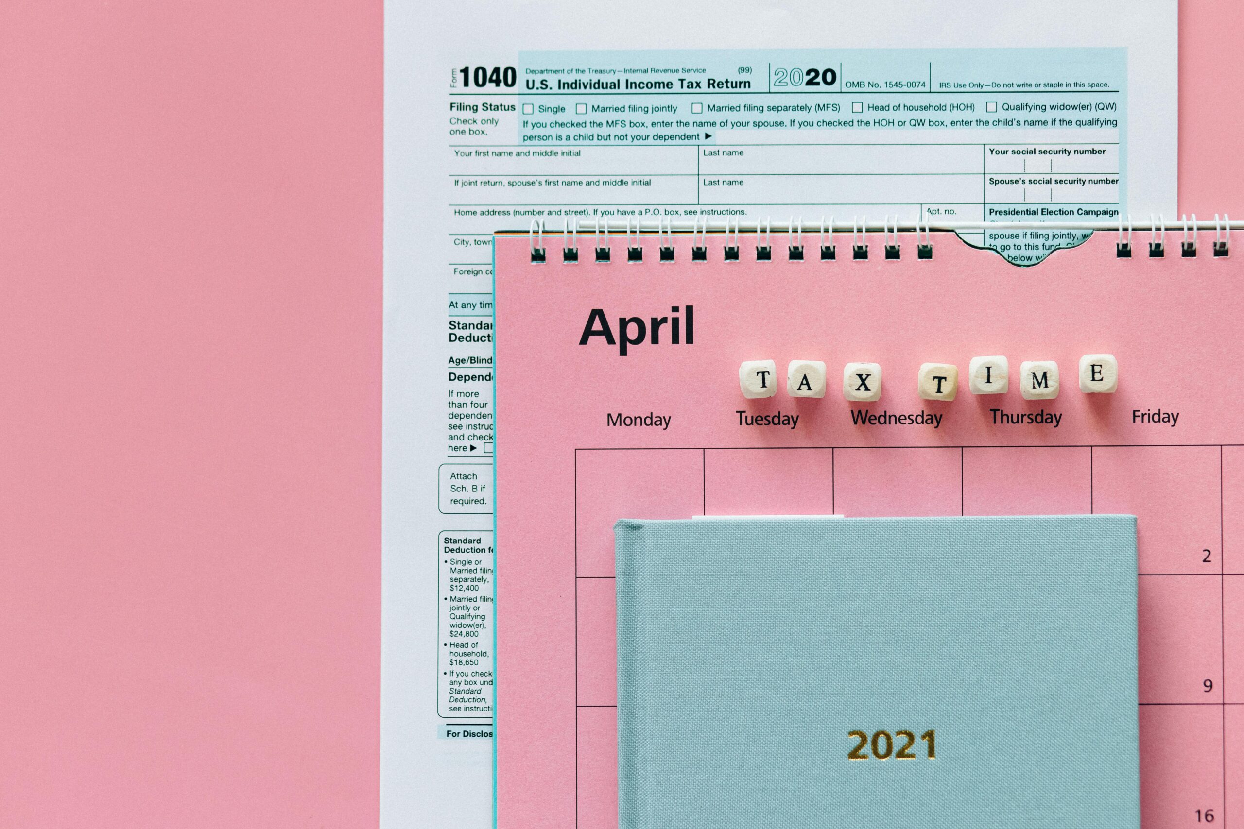 A calendar highlighting tax time in April with tax documents, emphasizing accounting services outsourcing.