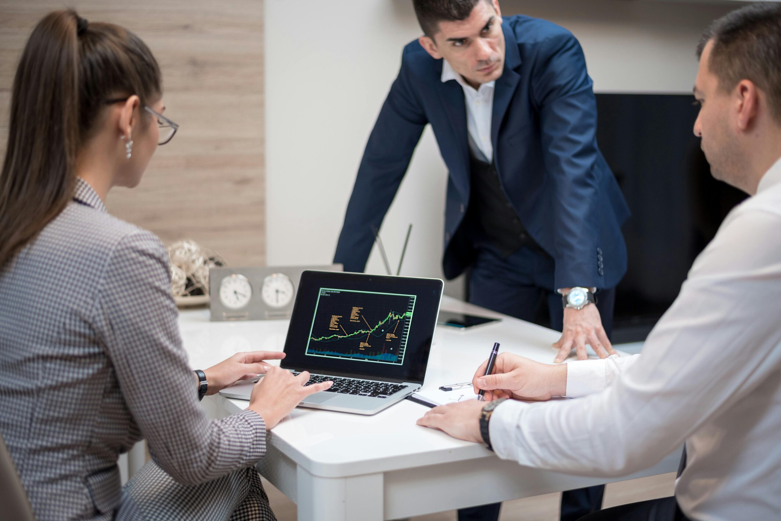A team reviewing data on a laptop.