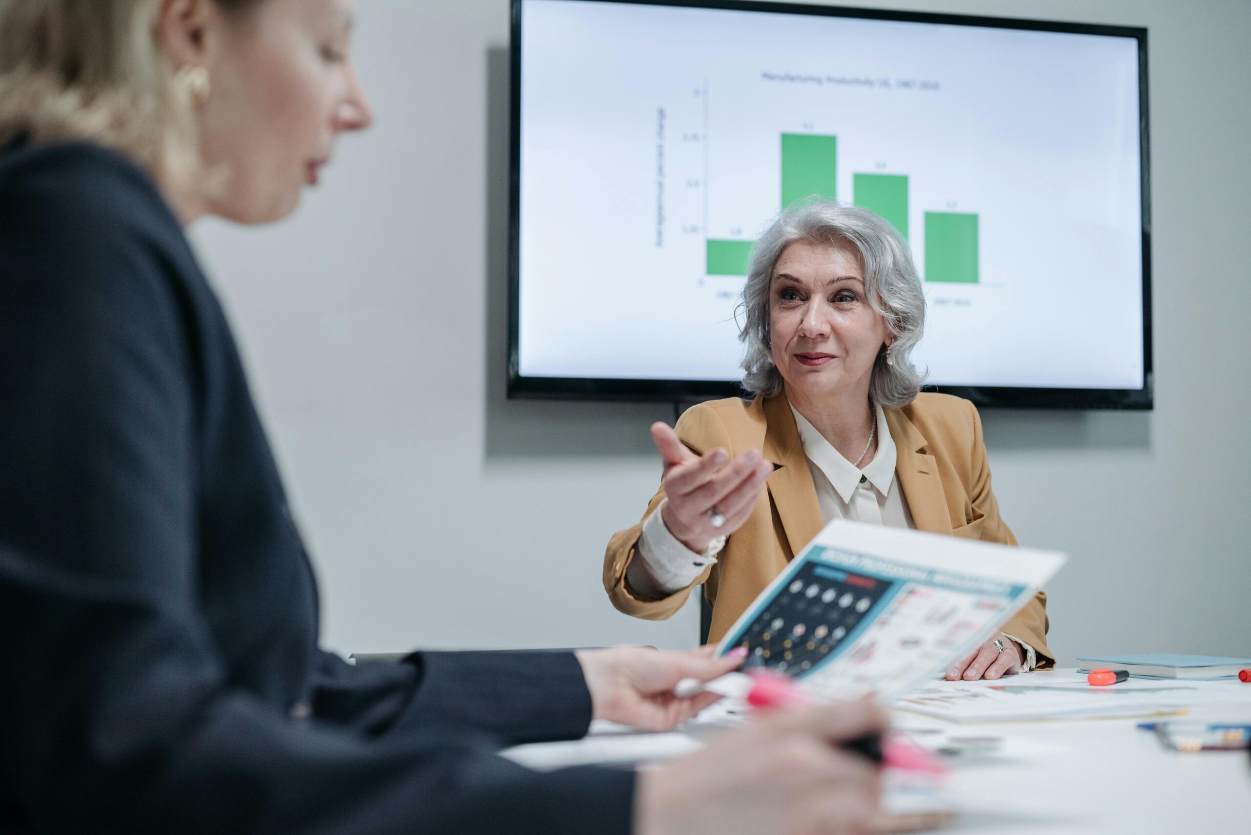 Senior woman explaining data during a meeting.