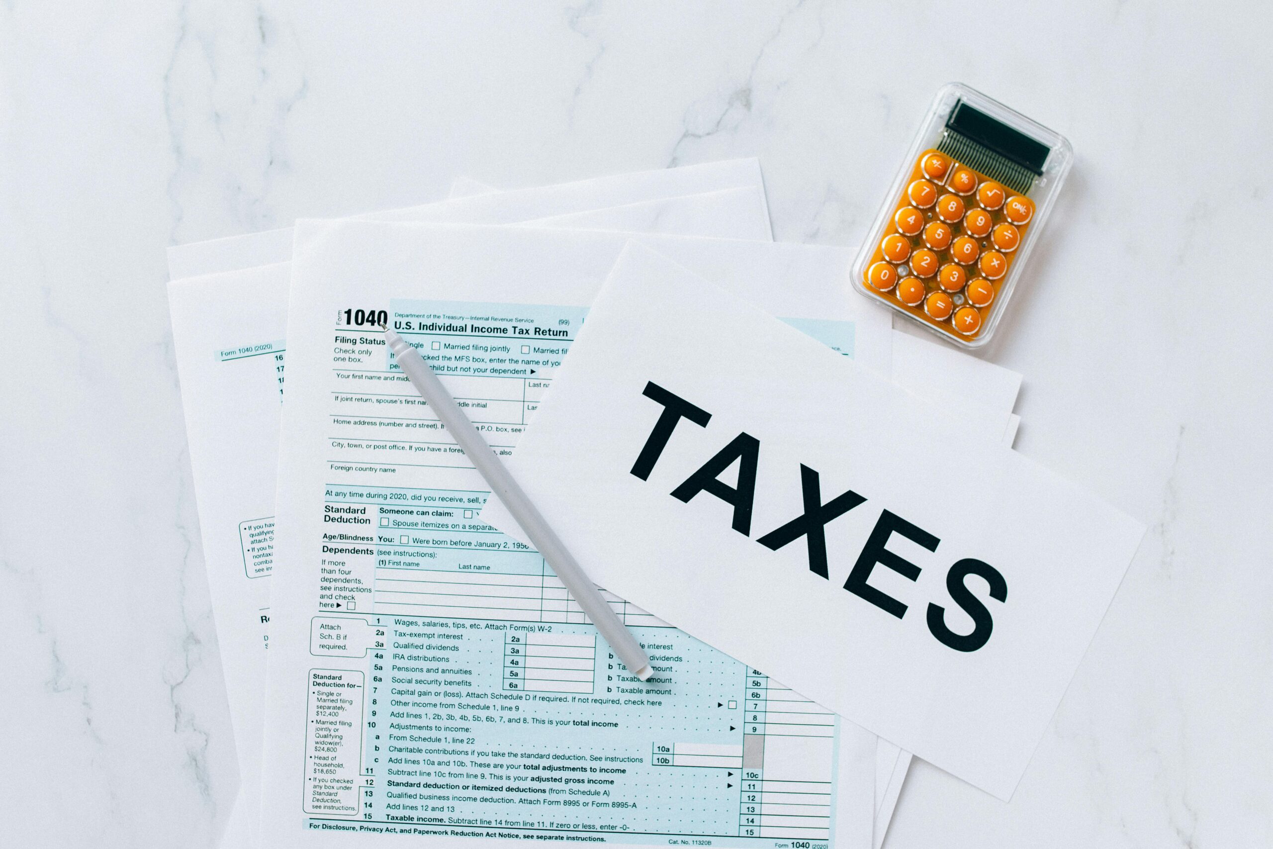 Tax forms and a calculator on a table.