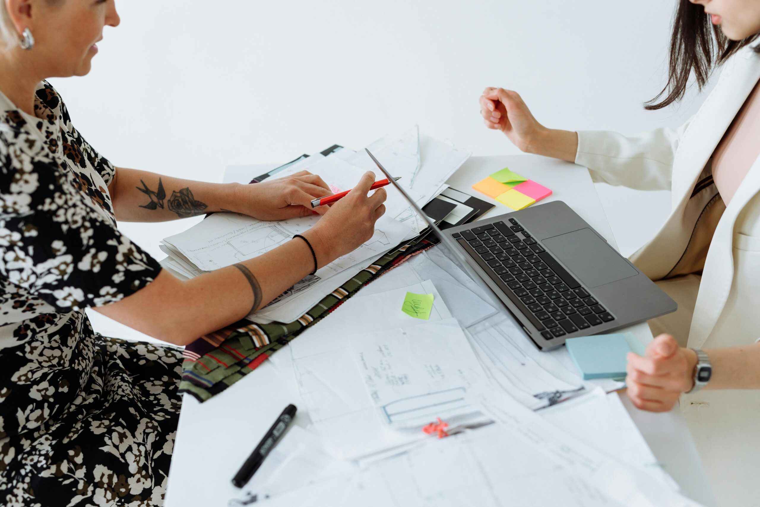 Business meeting with two professionals discussing plans, organized by top executive recruiting firms.