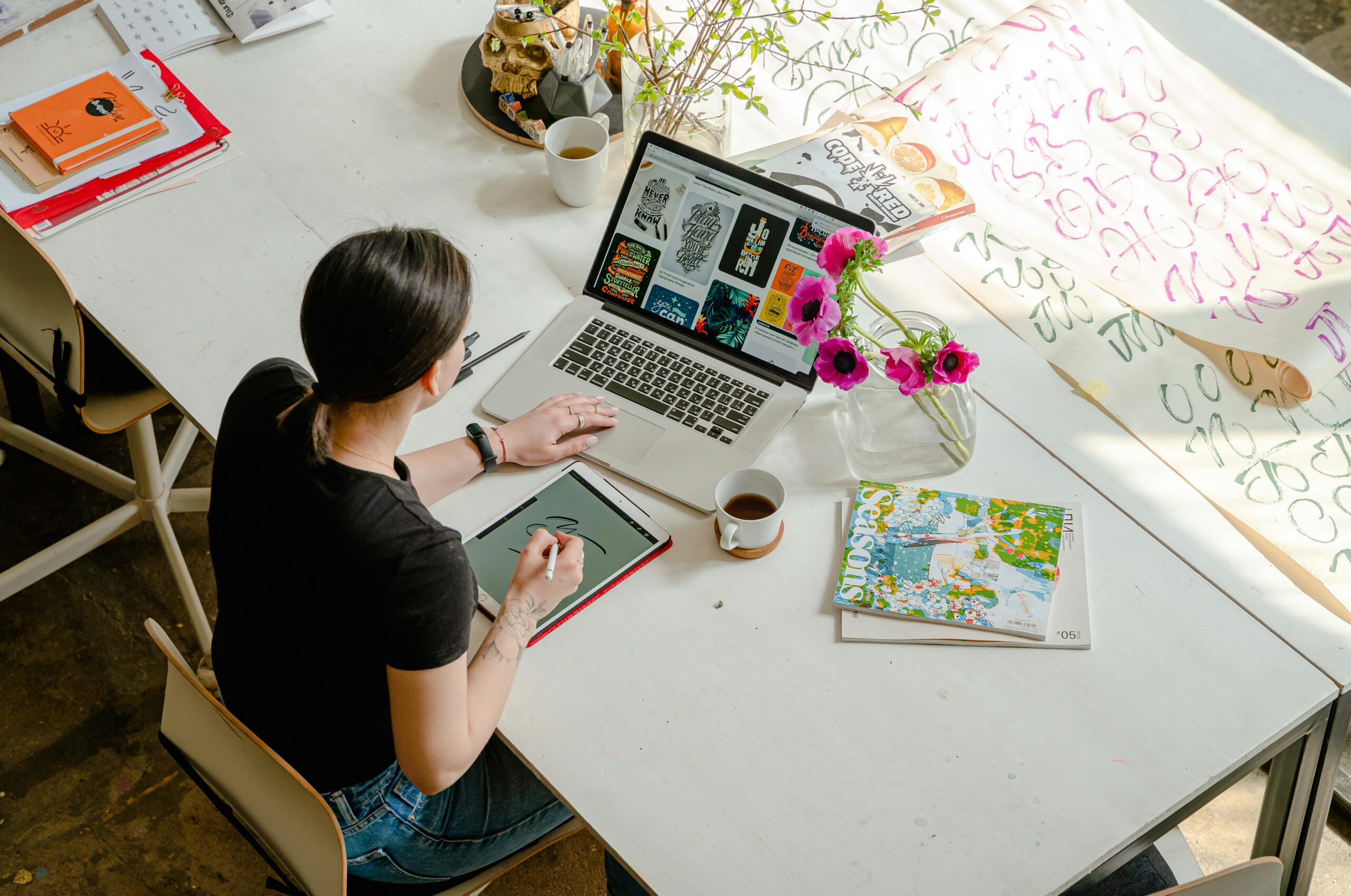 A person working on a graphic design project, demonstrating the benefits of hiring offshore talent for creative tasks.