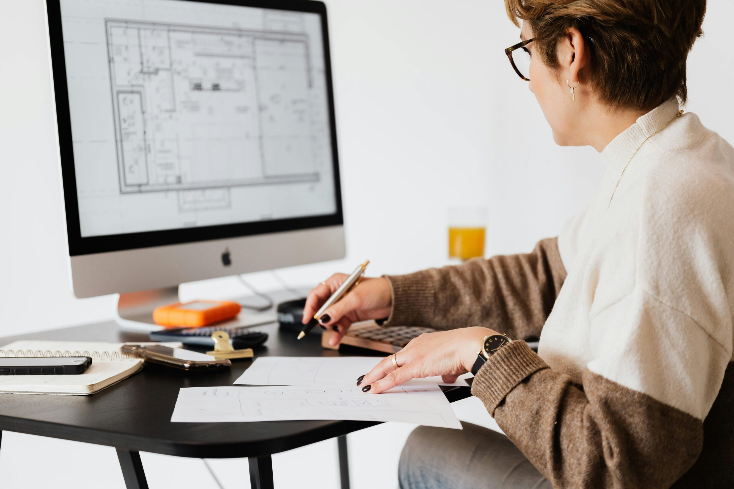 Woman working on architectural designs on a computer.