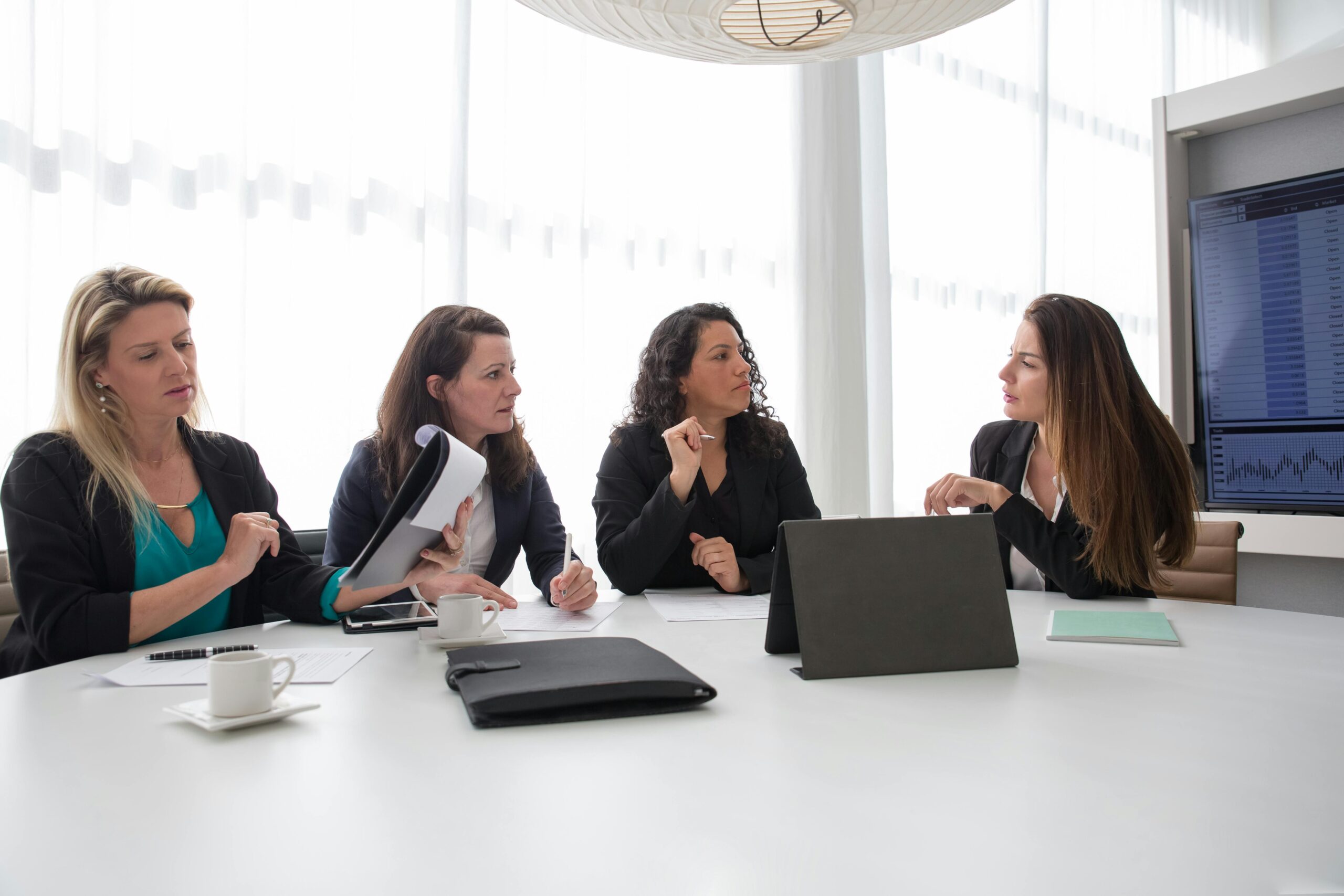 Team of professionals from remote recruiting agencies discussing recruitment strategies in a meeting.