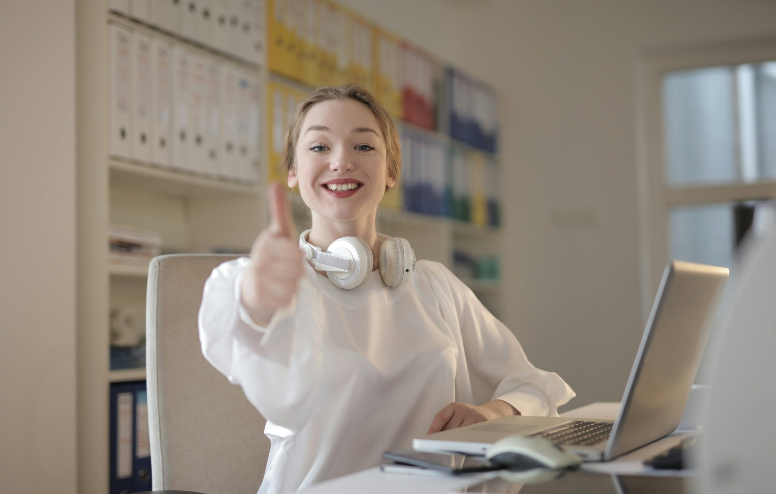Woman giving a thumbs up during a remote talent acquisition session.