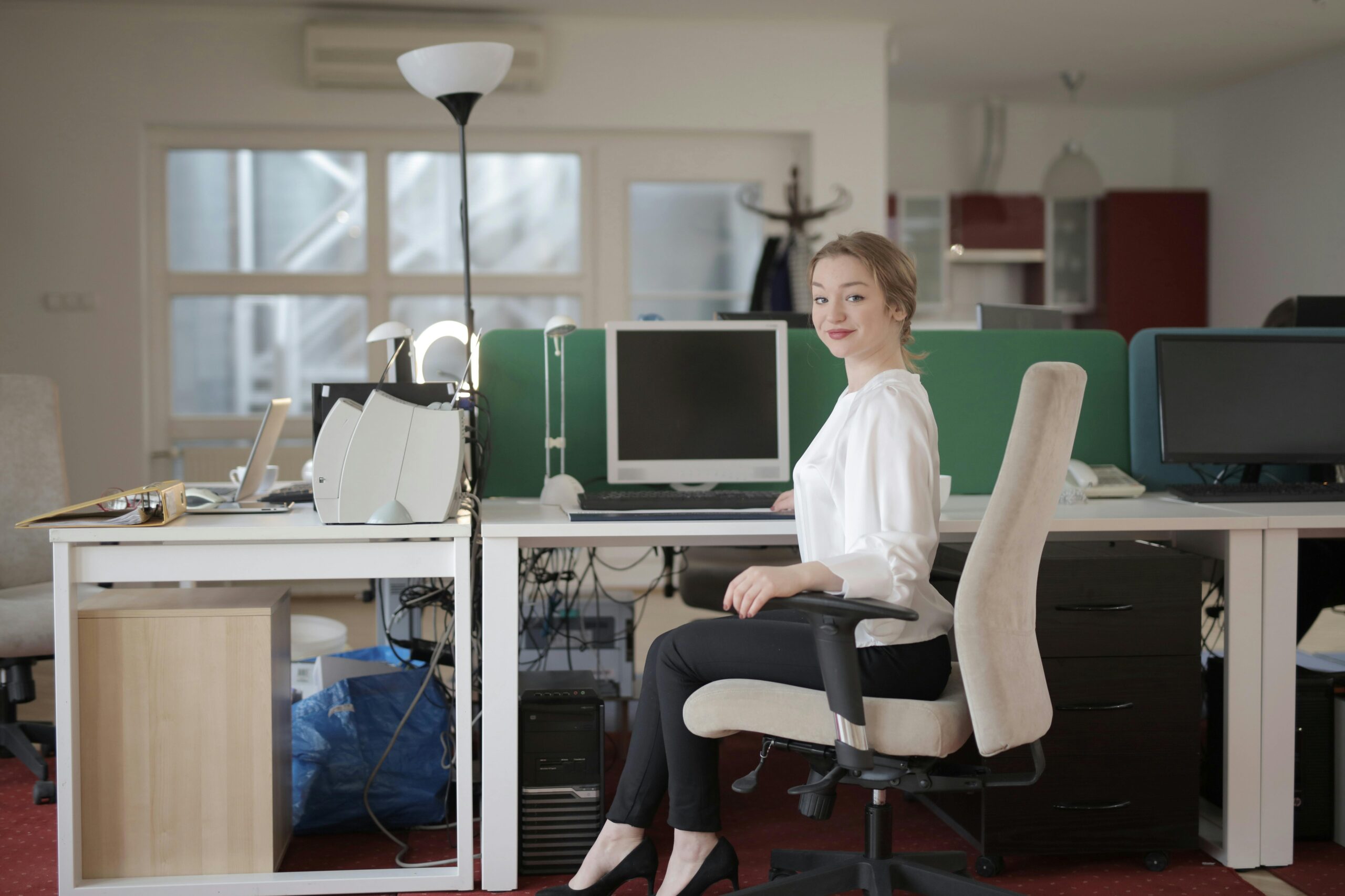 Professional woman at her desk in an admin assistant virtual job.