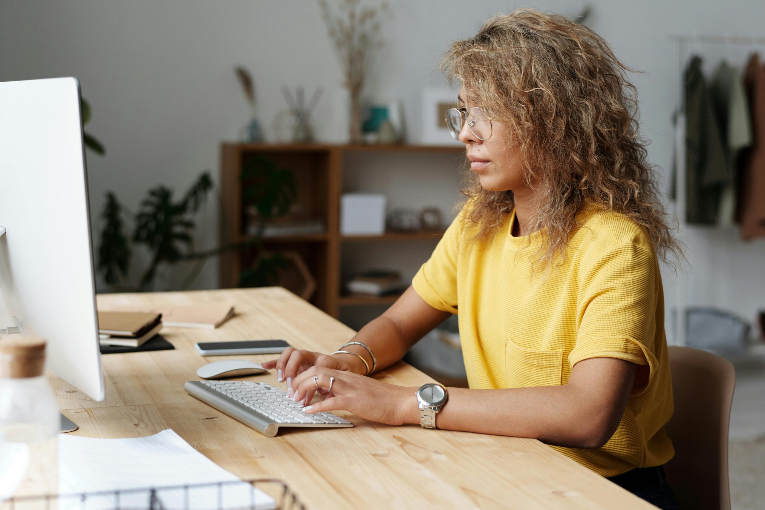 Focused woman typing in an admin assistant virtual job.