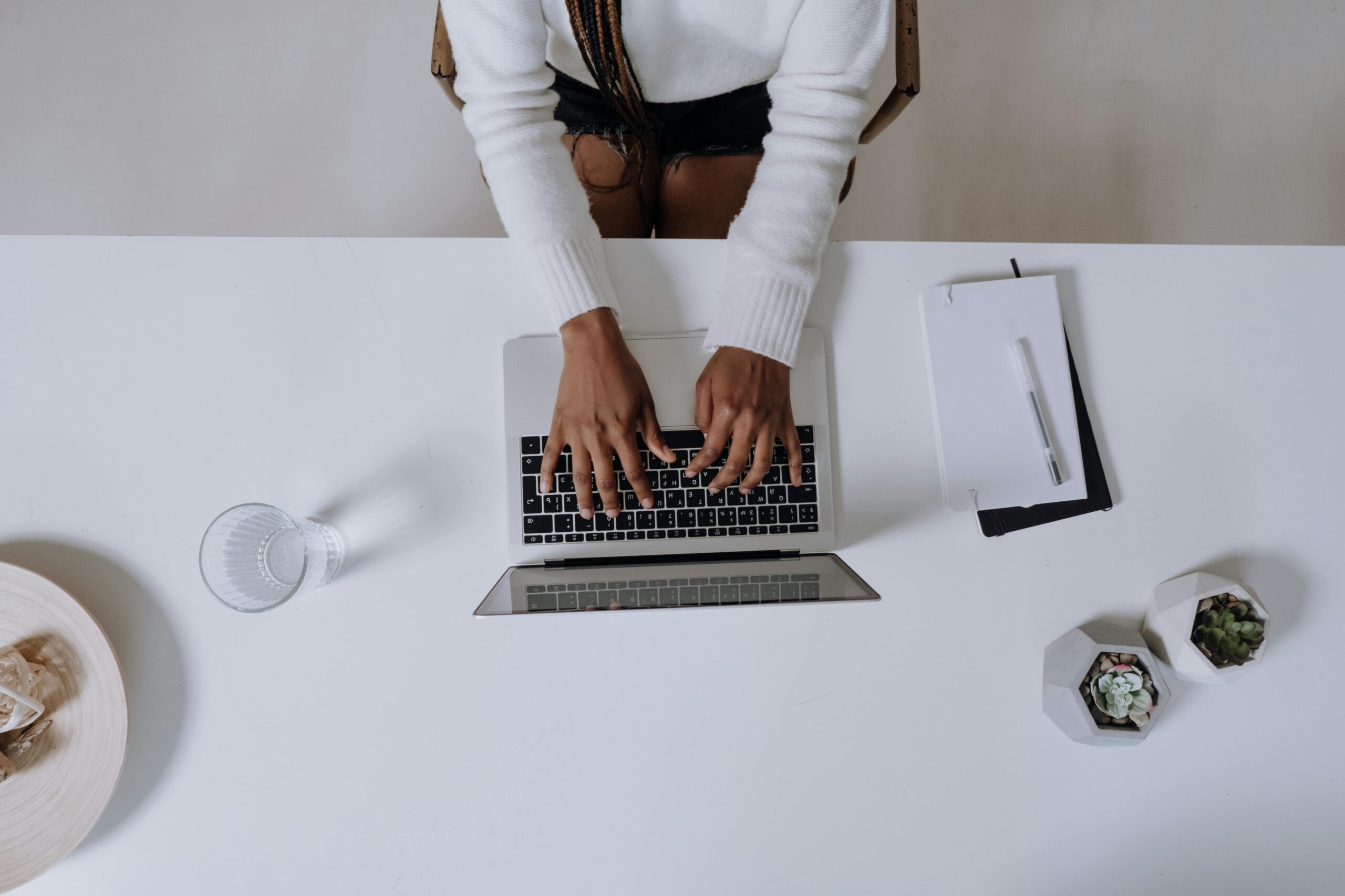 Person typing on a laptop.