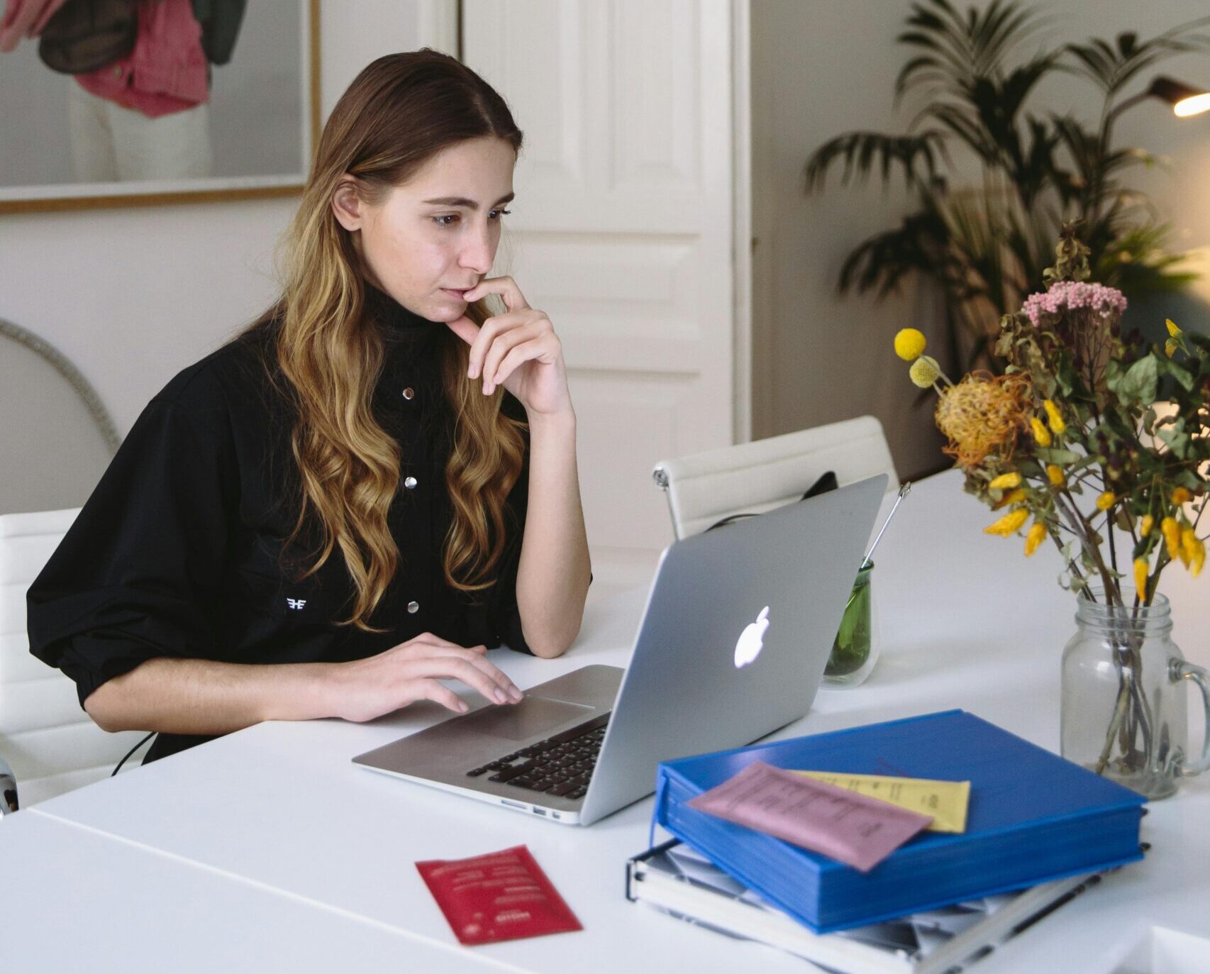 Focused woman working on her laptop, emphasizing the role of virtual assistants for startups.