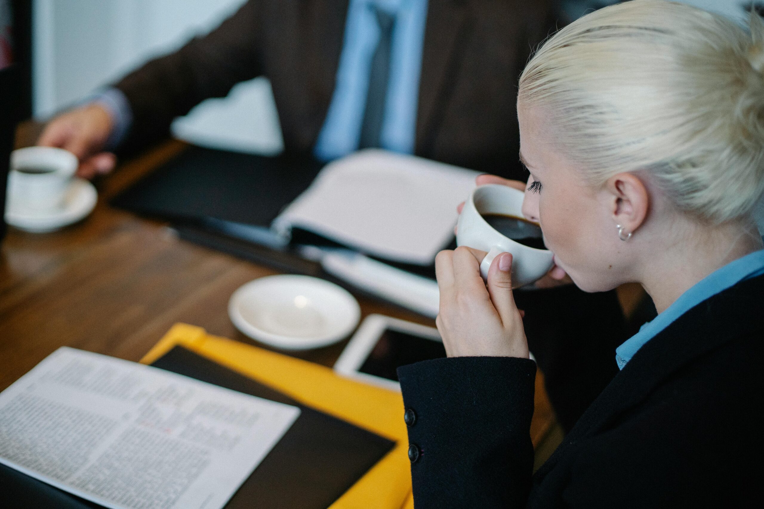 Reviewing documents to terminate a contract over coffee.