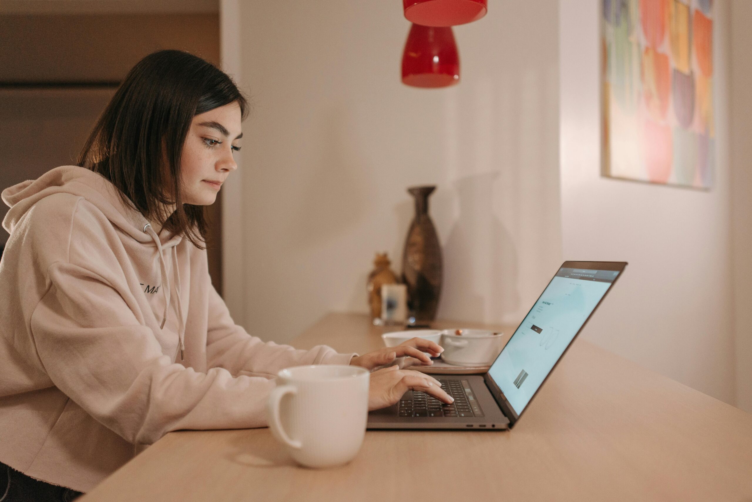 Woman focused on her laptop, learning how to get remote jobs through online resources.