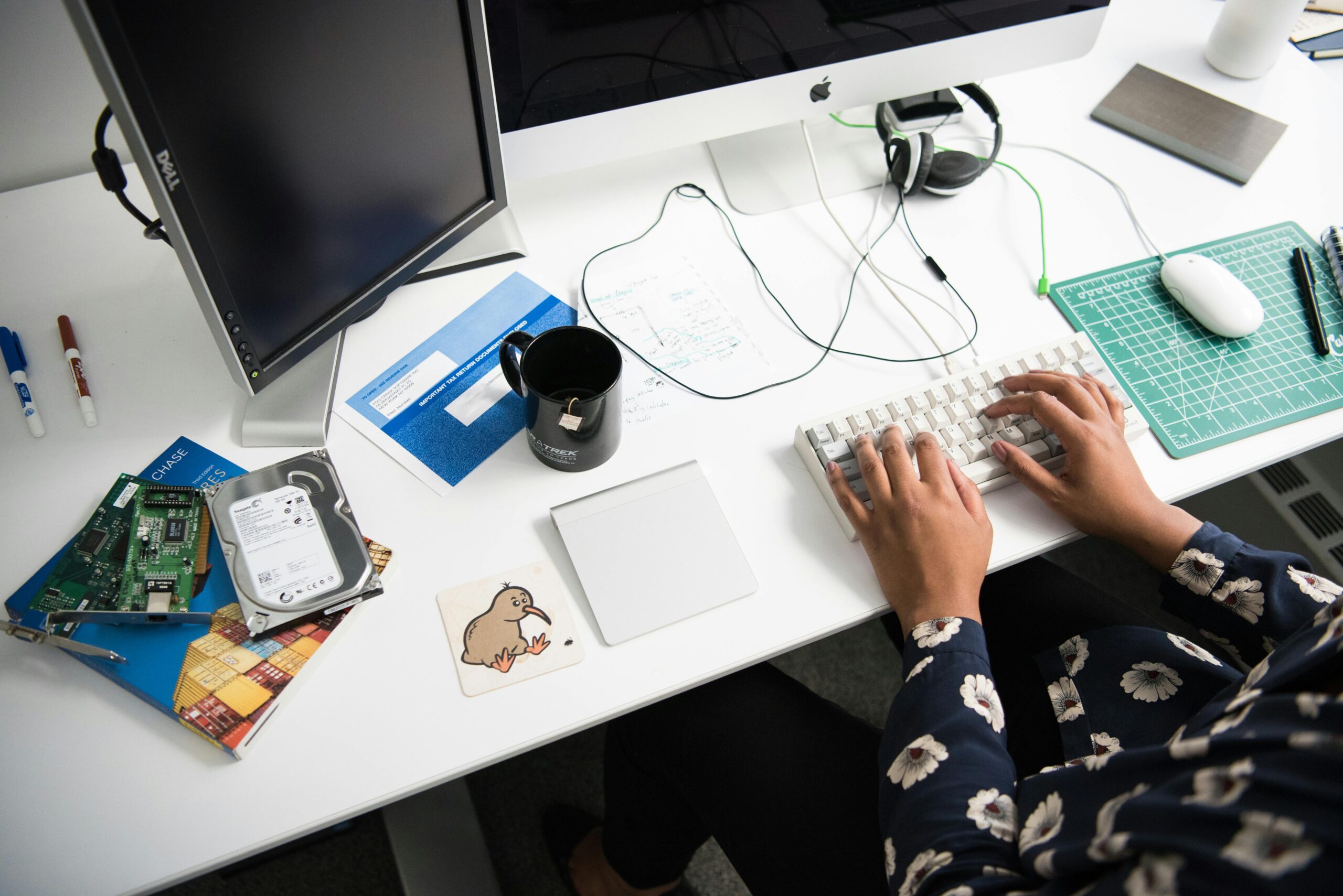 Person working on a desktop, analyzing remote closer salary data.