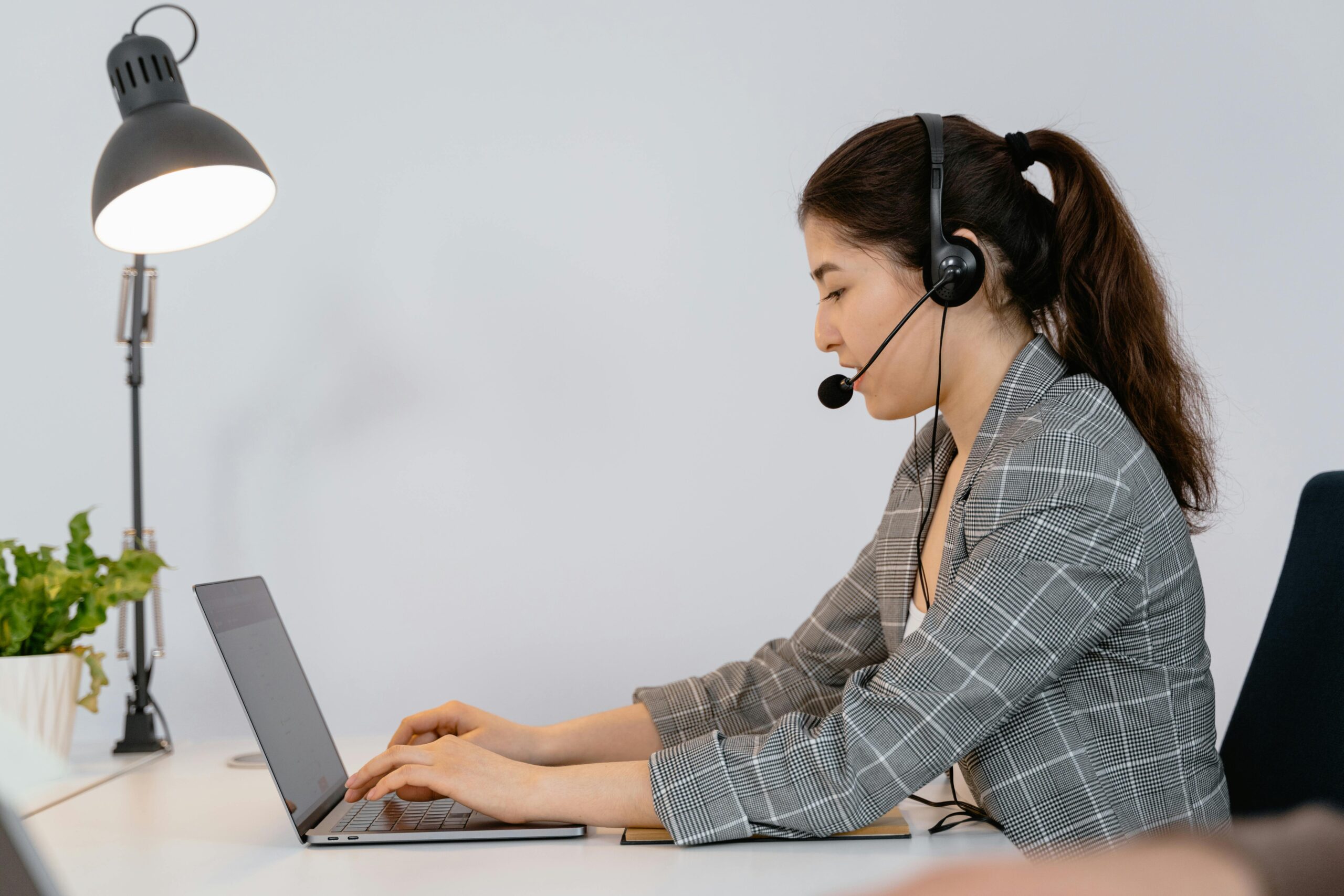 Professional woman working remotely, discussing remote closer salary details.