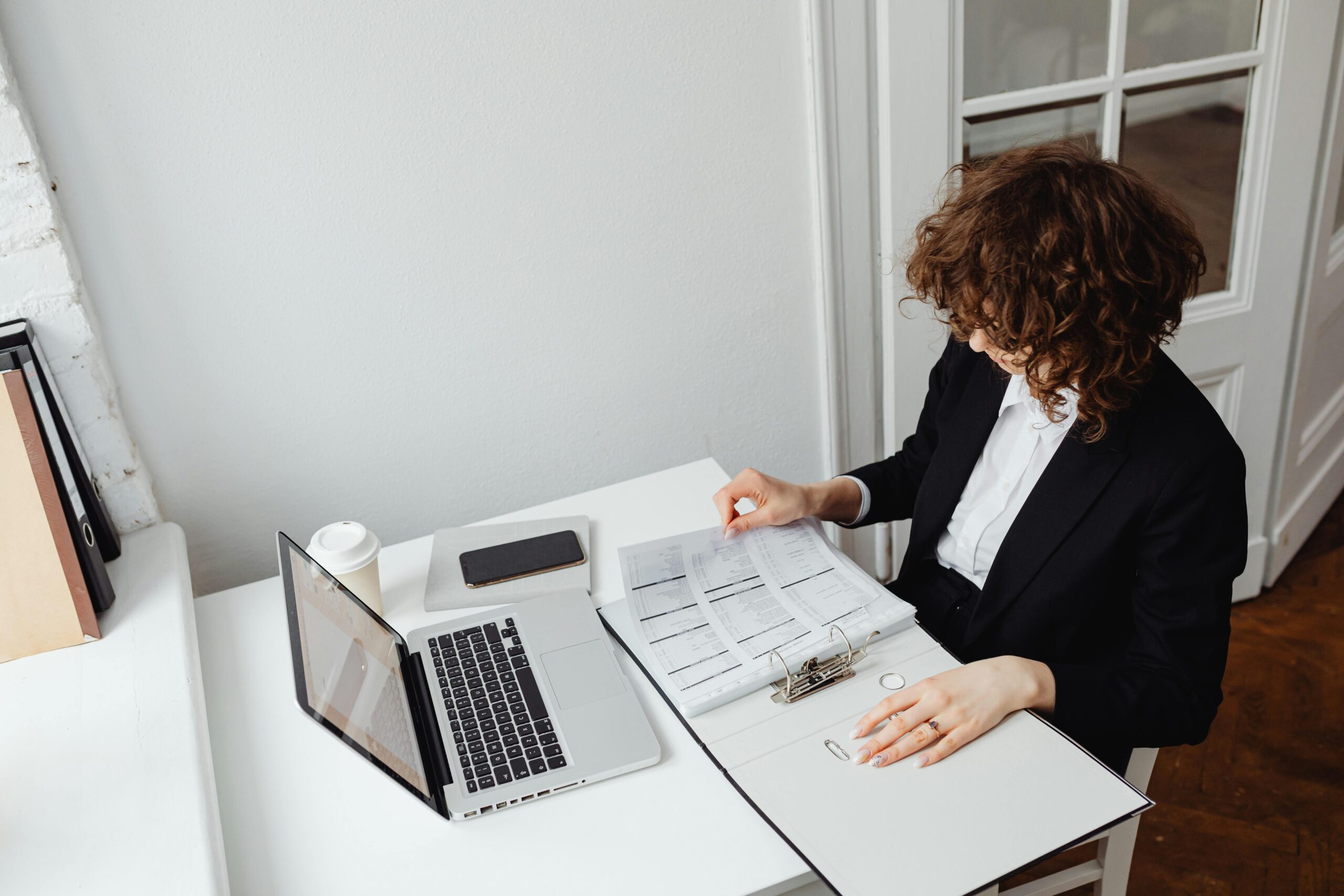 Woman reviewing documents at her desk.