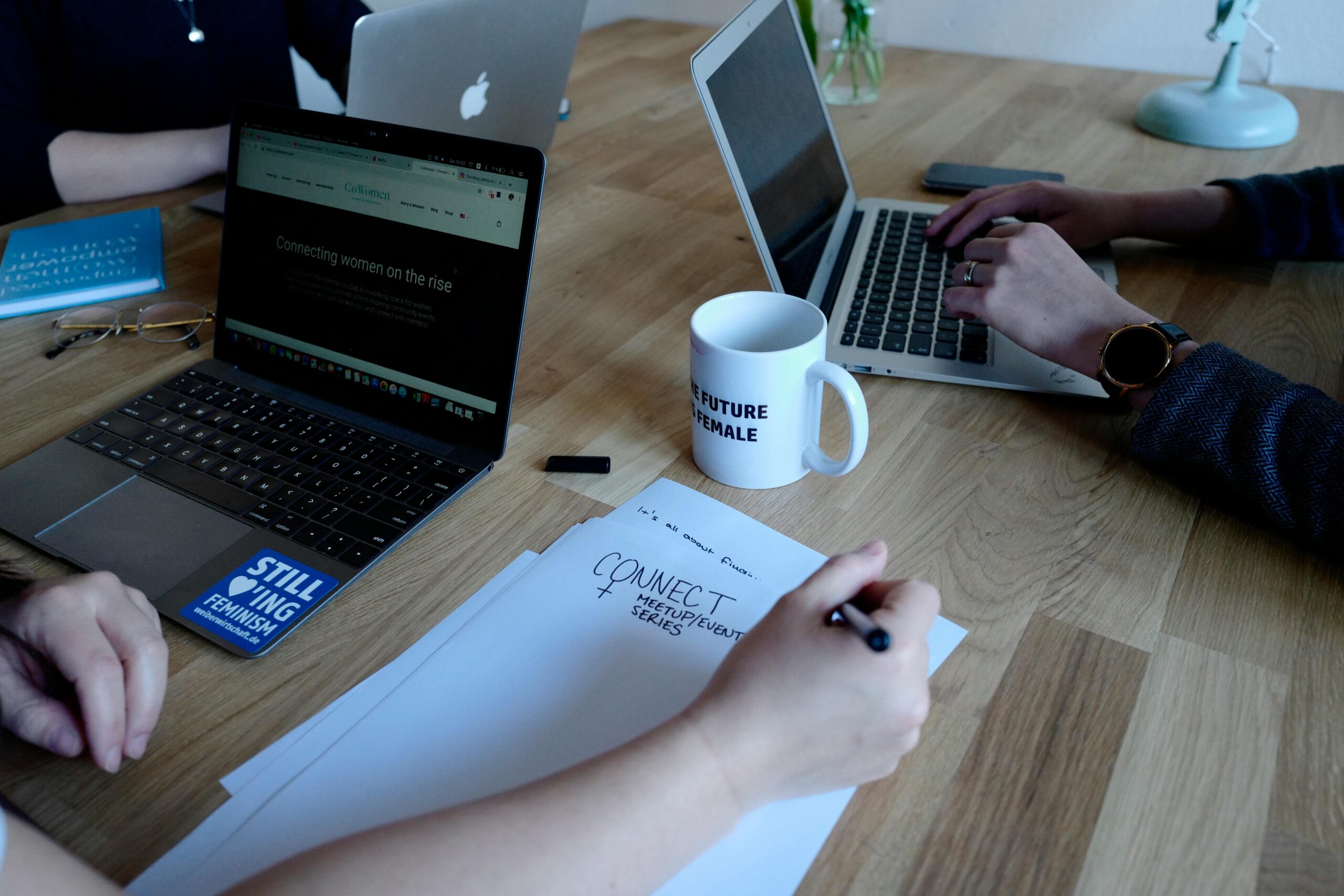 Team collaboration with laptops and notes, highlighting the role of a part-time copywriter.