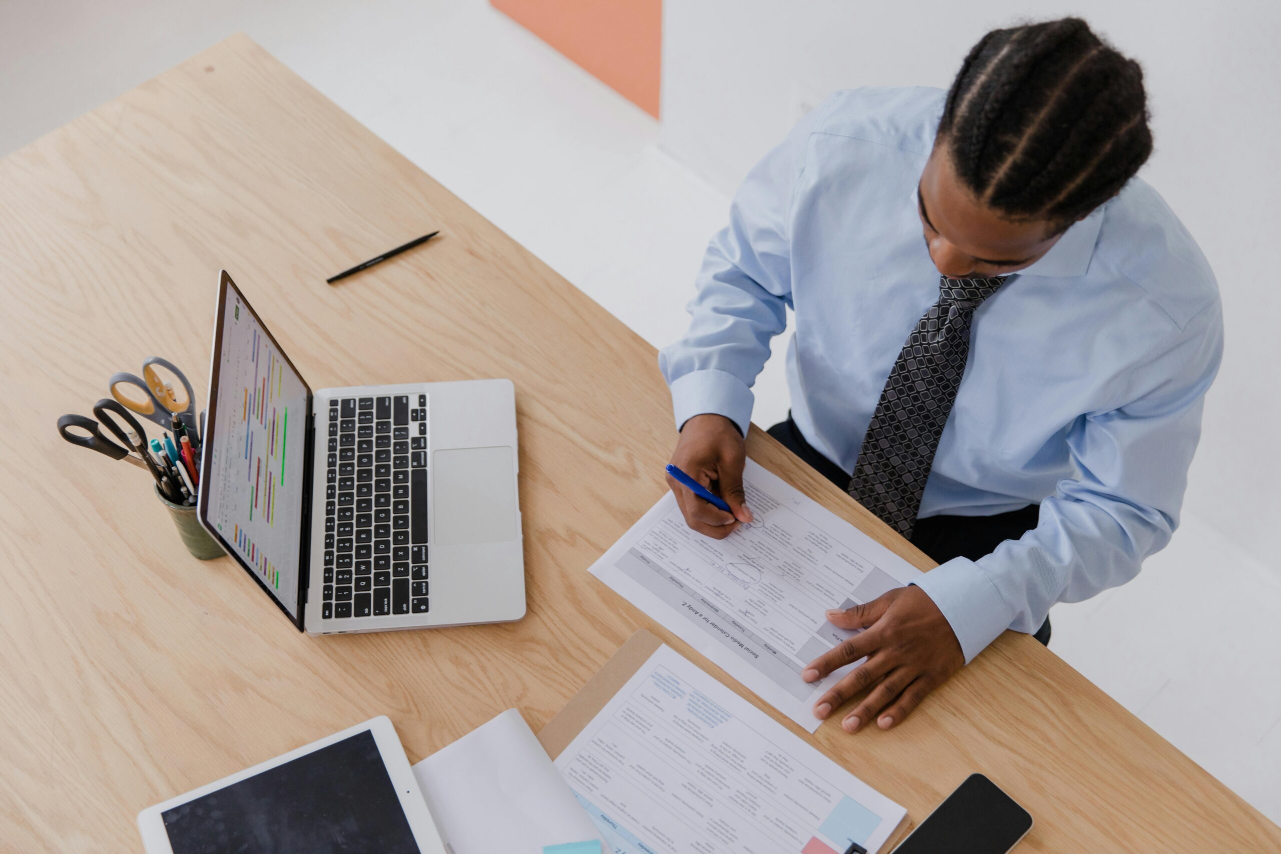 Businessman working on a format for a contract agreement. at his desk with a laptop.