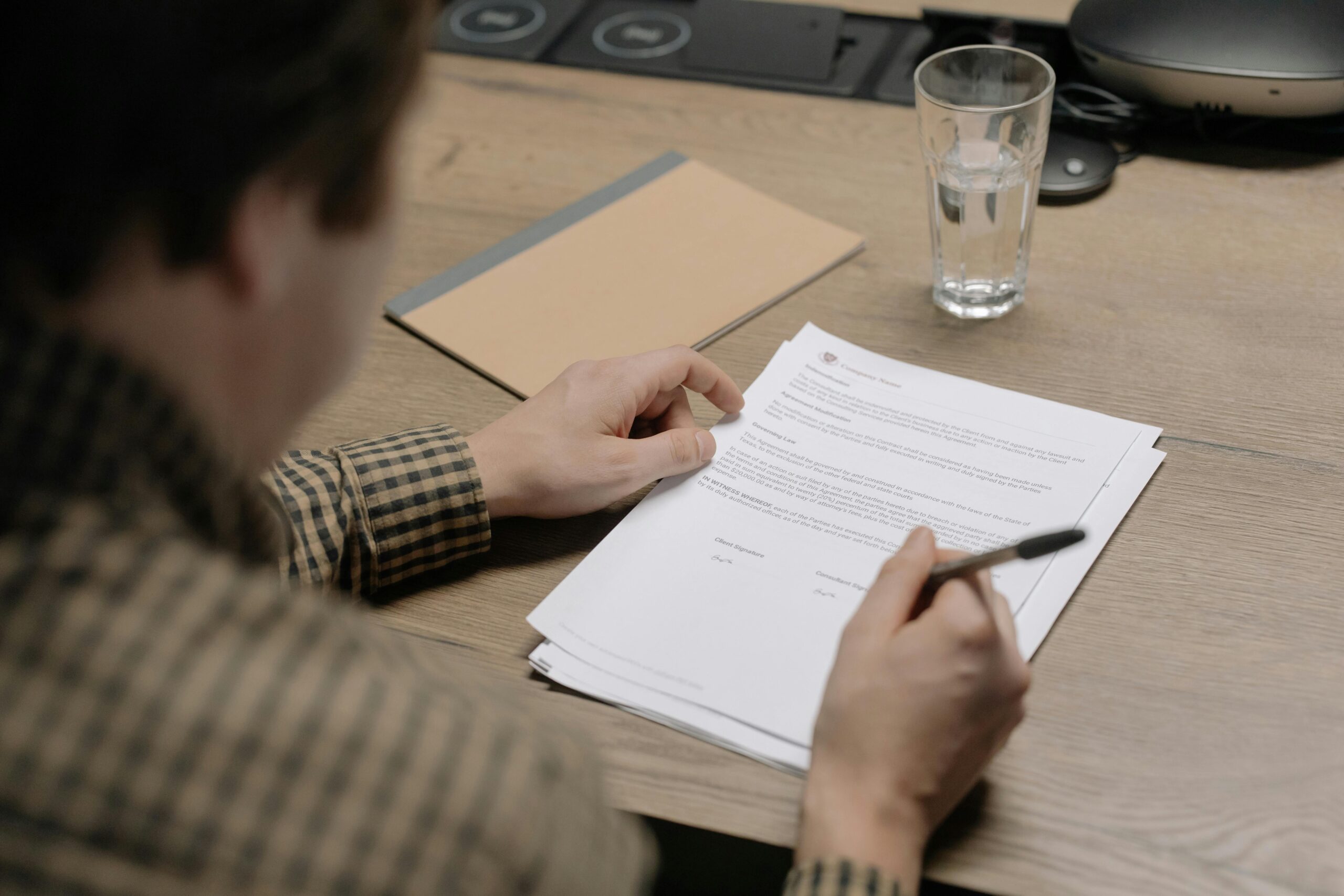 A professional reviewing an executive assistant job description document before an important meeting.