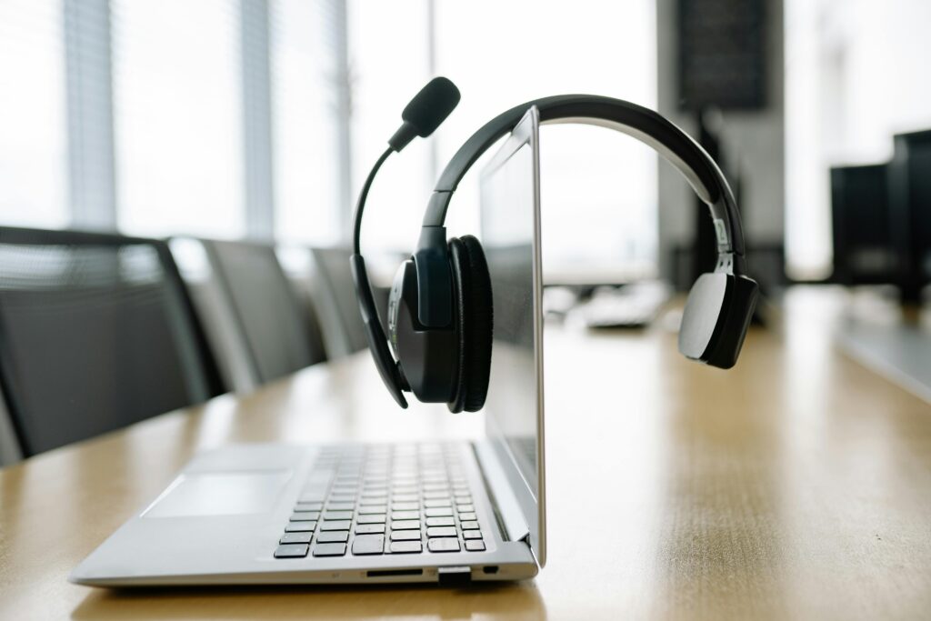 Headset resting on a laptop, symbolizing inside sales outsourcing support.