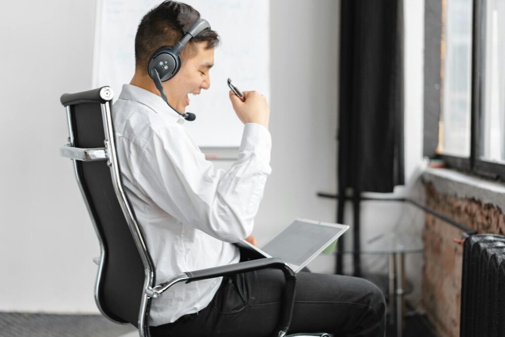 A male professional with a headset enthusiastically engaging during an online meeting, emphasizing virtual assistant for healthcare services.A motivated professional participates in a virtual discussion, highlighting the value of virtual assistants in providing seamless support to healthcare providers.