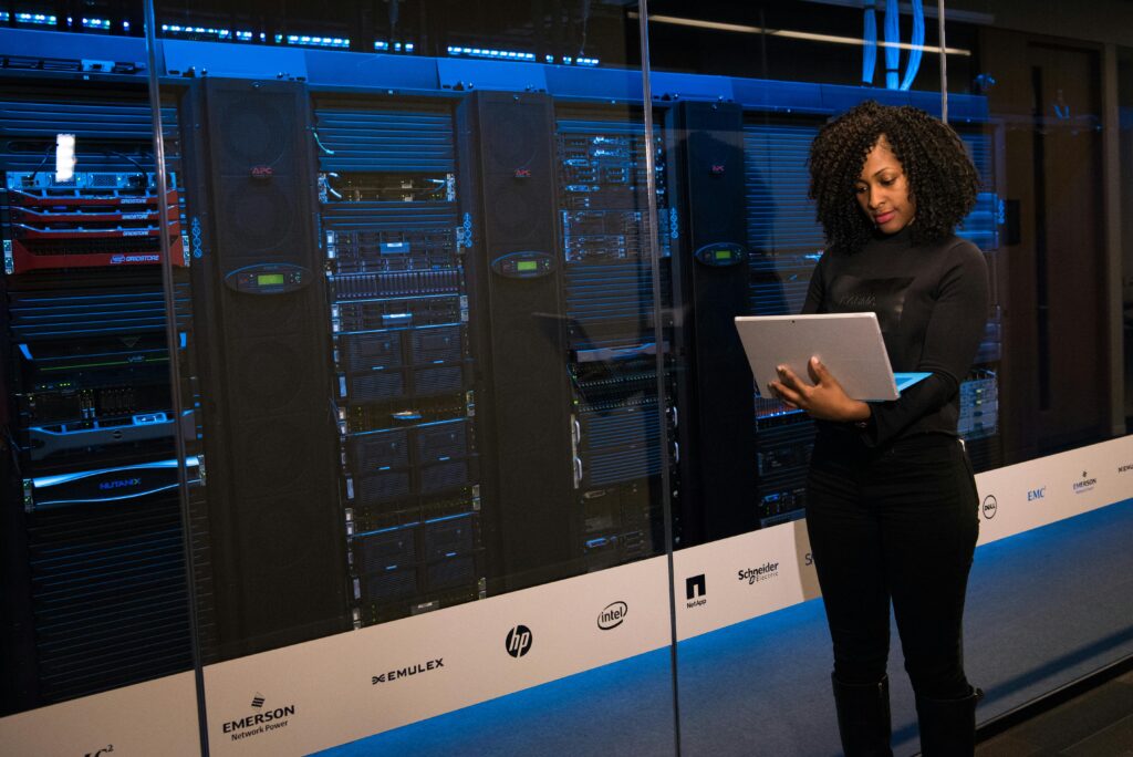 A professional managing outsourced network management in a data center with advanced servers.