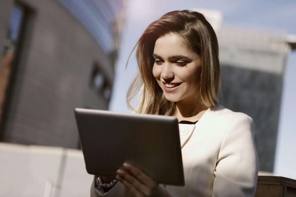 A community manager engaging with an online audience using a tablet, strategizing digital content and brand interactions.
