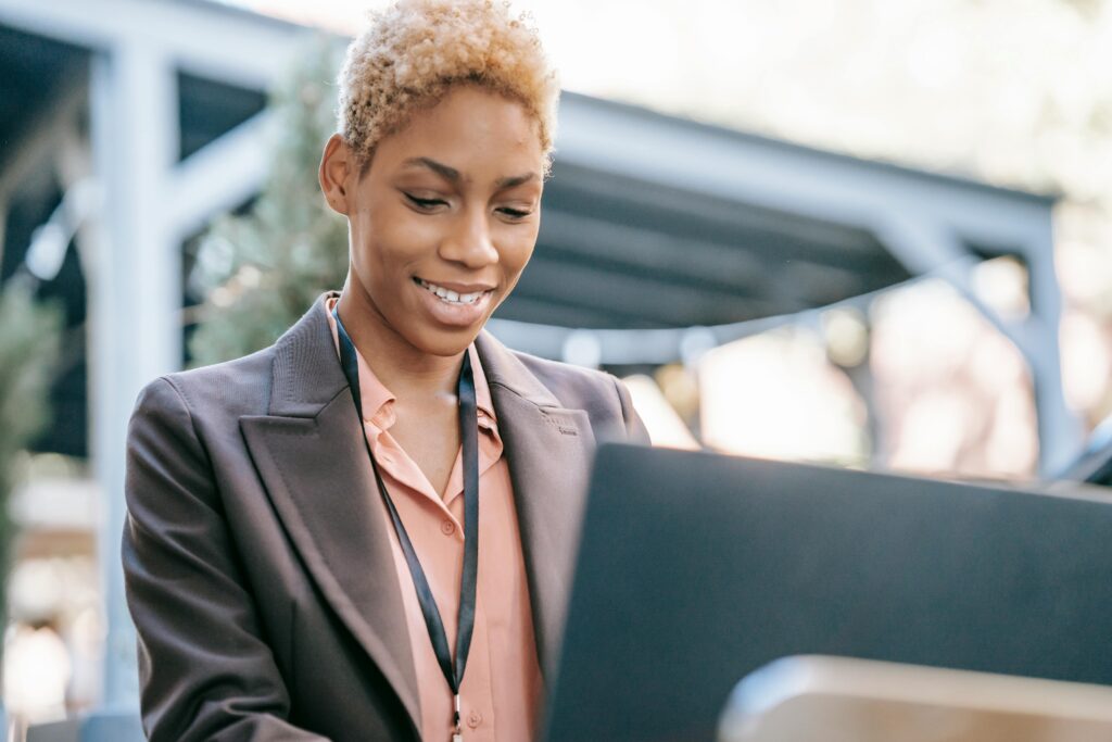 HR generalist working on a laptop outdoors.