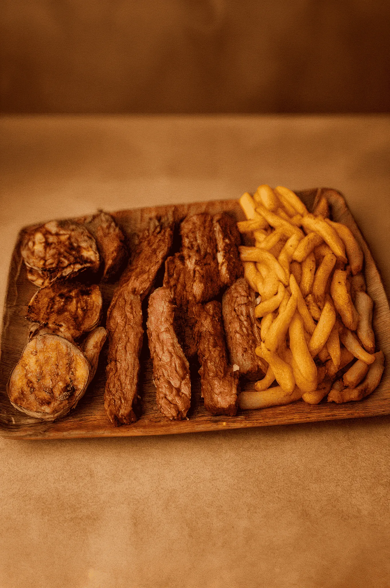 Grilled steak strips with roasted vegetables and crispy french fries