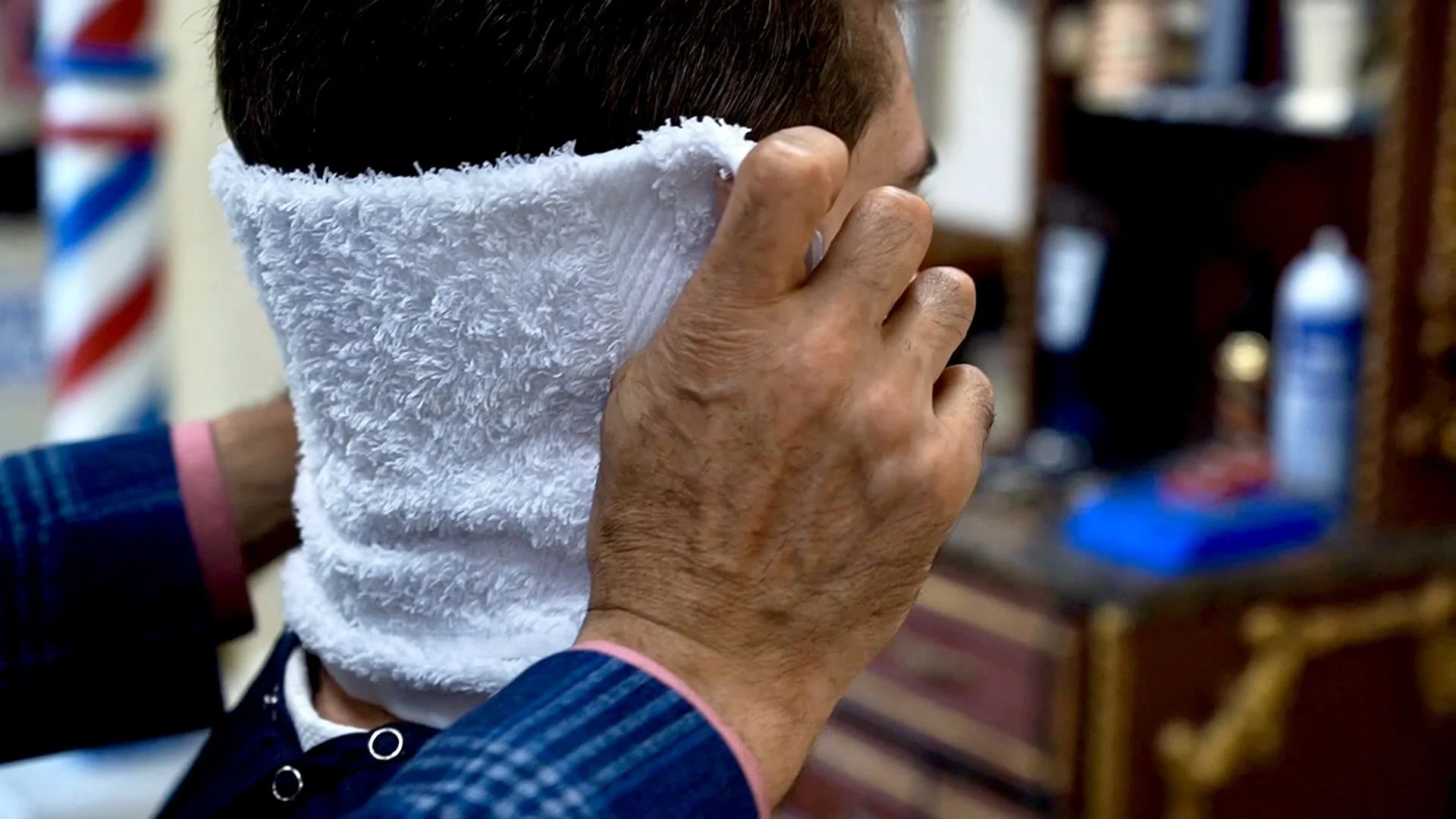 A client getting a hot towel shave at our Sunny Isles Beach barber shop
