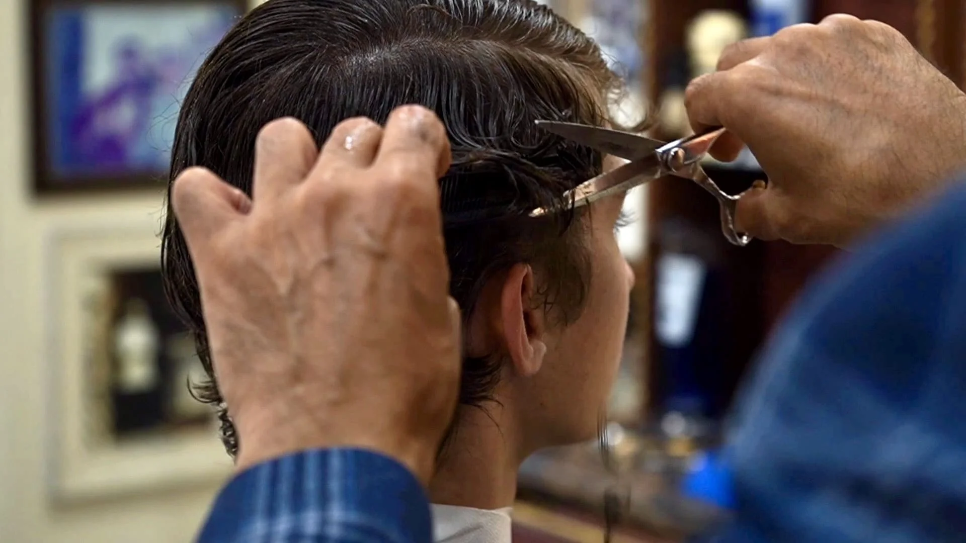 A client receiving a haircut using the scissor and comb technique