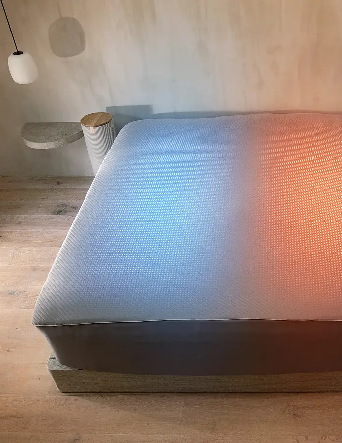 A image of the Orion Smart Cover, showing a cooling effect on the left side of the bed, and a heating effect on the right. 