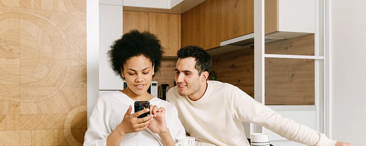 A man and a woman looking at a phone.