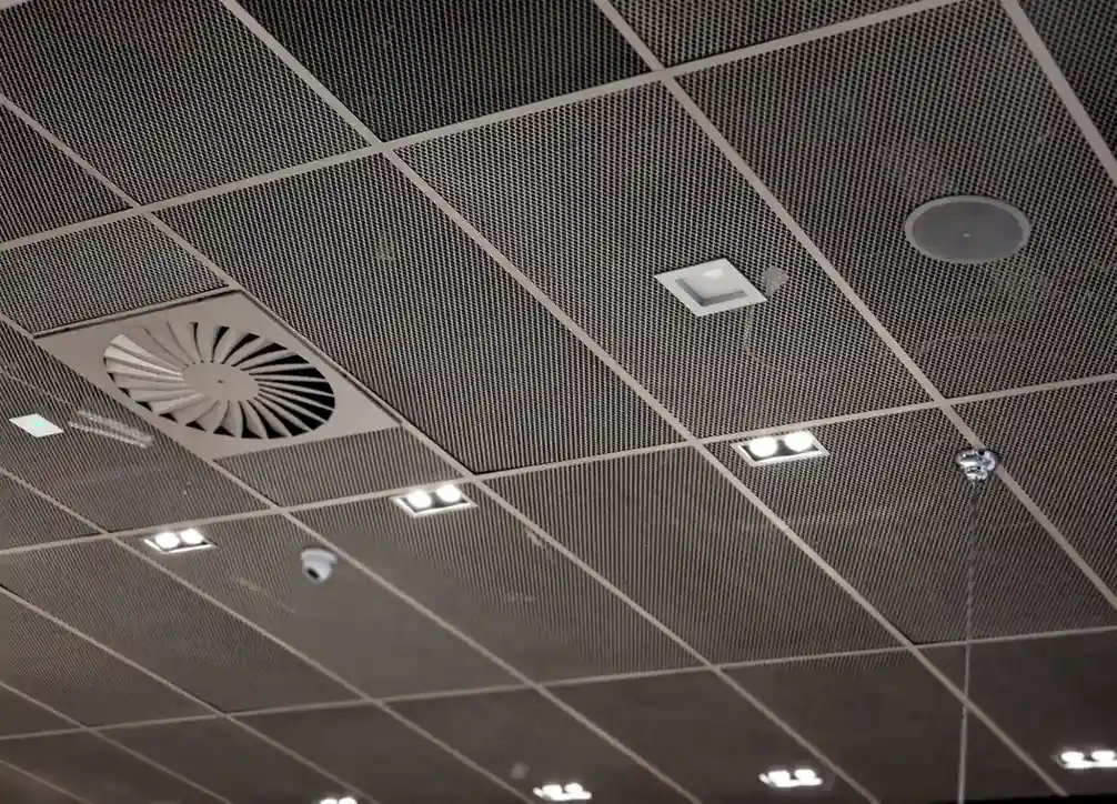 Ceiling with a perforated metal grid and ventilation fan