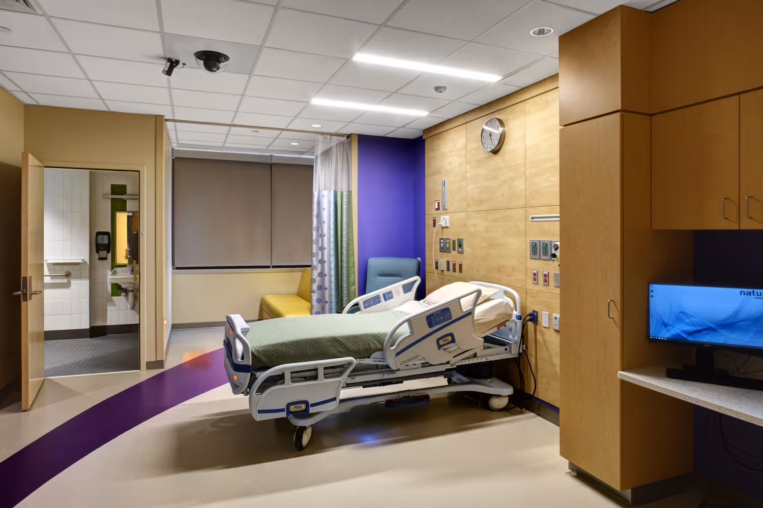 Modern, private hospital patient room.