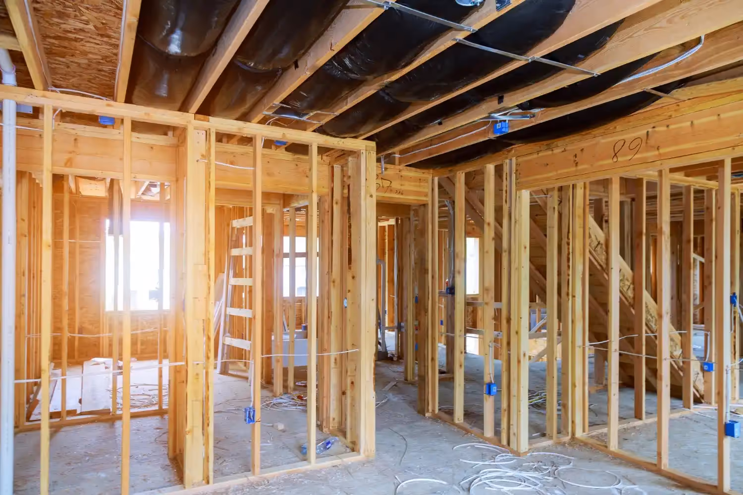  A comprehensive collection of HVAC images shows all aspects of the trade: a four-person team installs a large outdoor AC condenser on a house, while other images feature technicians working on smaller residential equipment, including inspecting a furnace in an attic and servicing a wall-mounted mini-split unit. Further images illustrate two technicians installing a modern vertical furnace/air handler and another installing a thermostat near a boiler system. Finally, multiple photos showcase the complex, large-scale HVAC infrastructure required for medical or commercial facilities, highlighting silver ductwork, intricate piping, and vast air handling units.