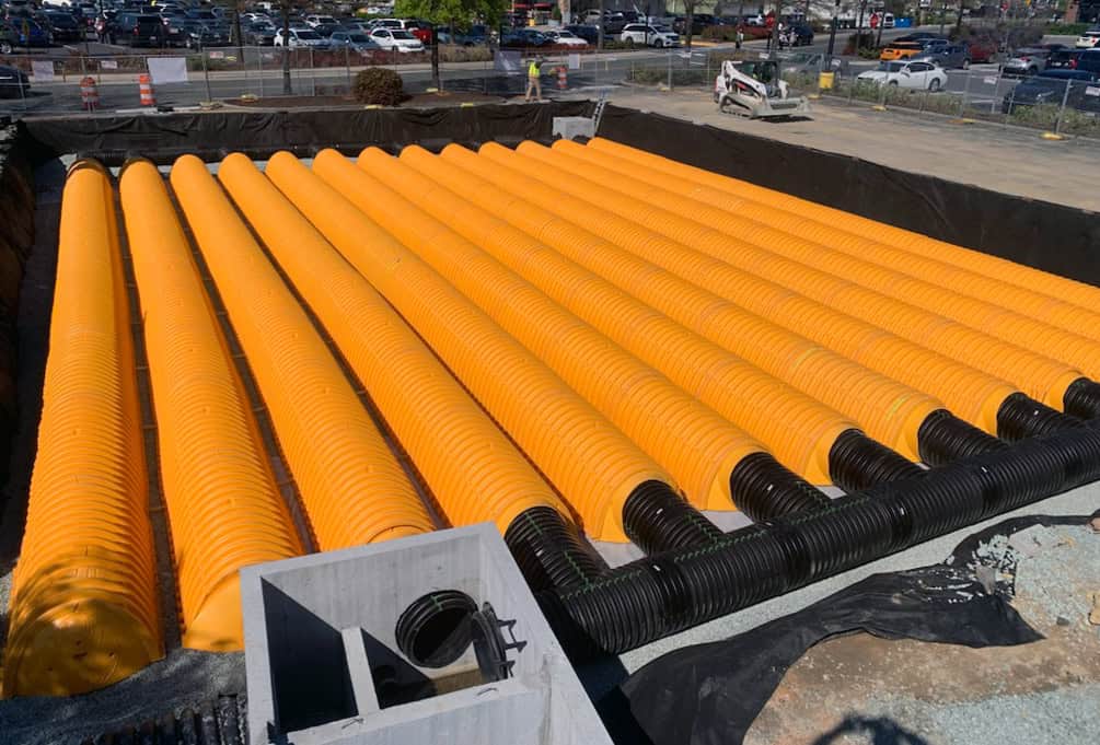 Rows of orange corrugated chambers in an excavation at Eastgate Shopping Center in Chapel Hill, NC.