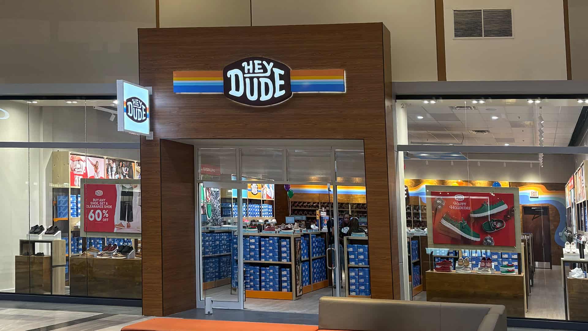 Hey Dude storefront at Concord Mills, NC, with a tall signed entrance and glass display windows.