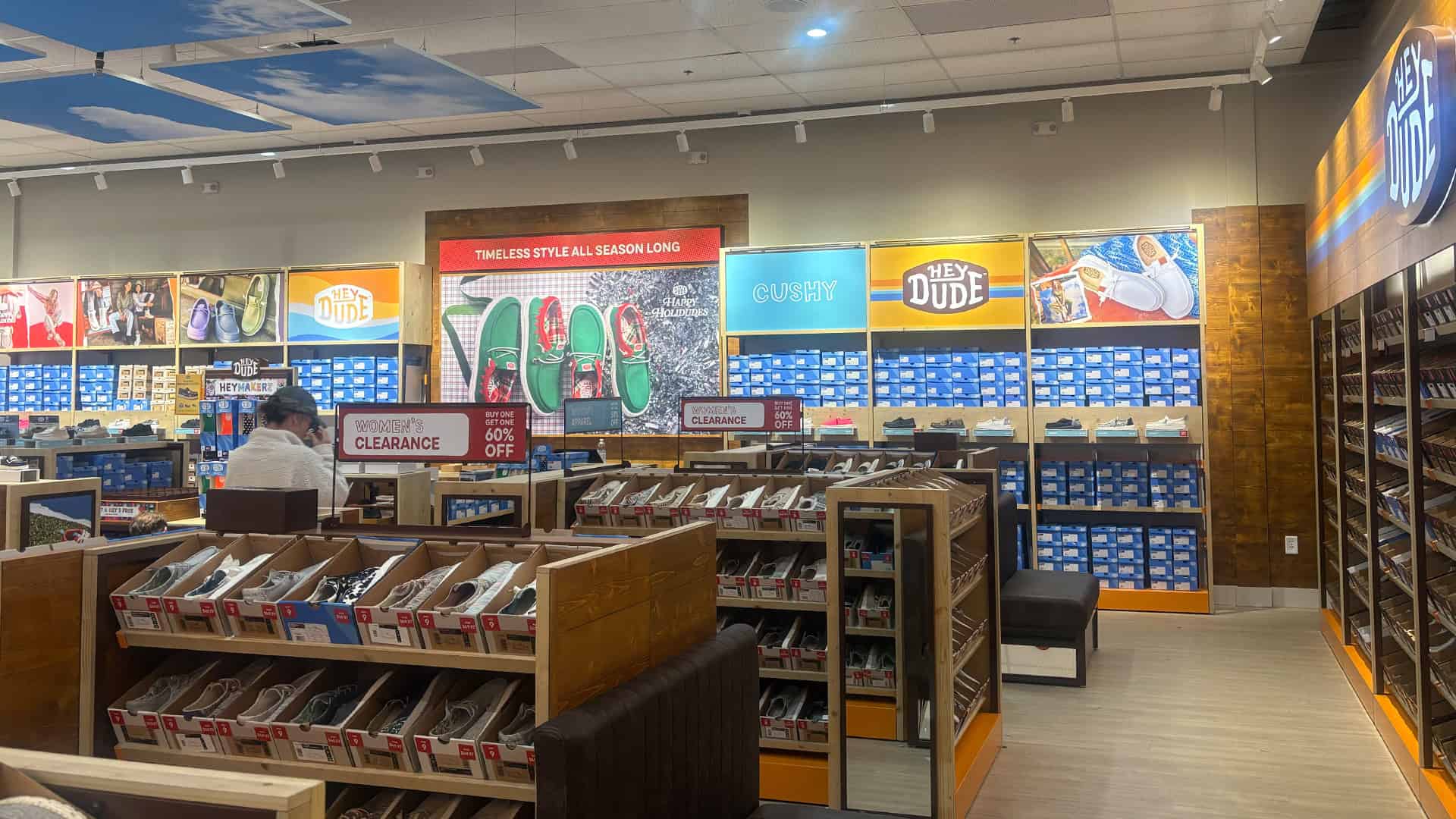 Rows of shoe displays and boxed stock inside Hey Dude at Concord Mills, NC.