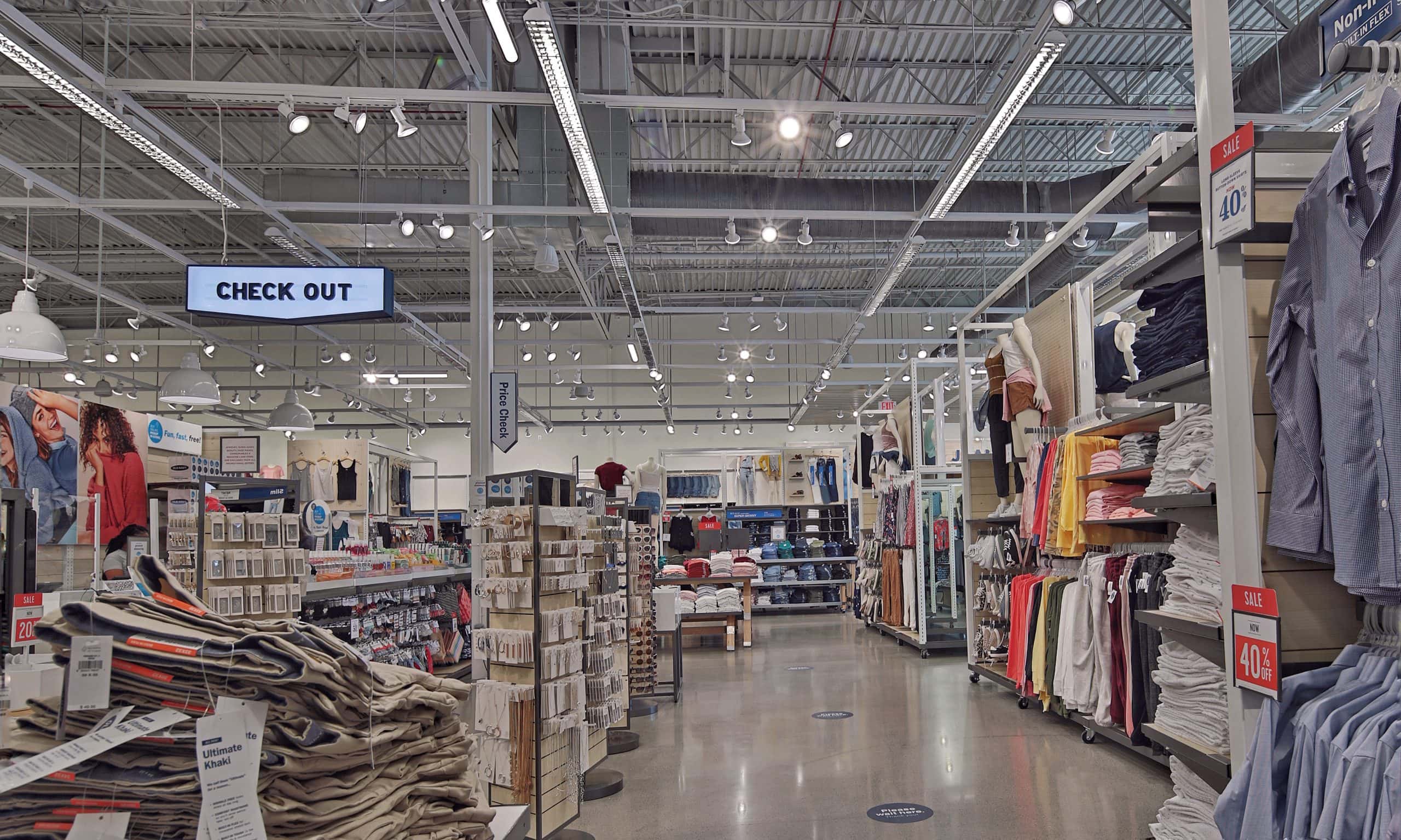 Clothing displays and a checkout sign inside Old Navy in Evans, GA.