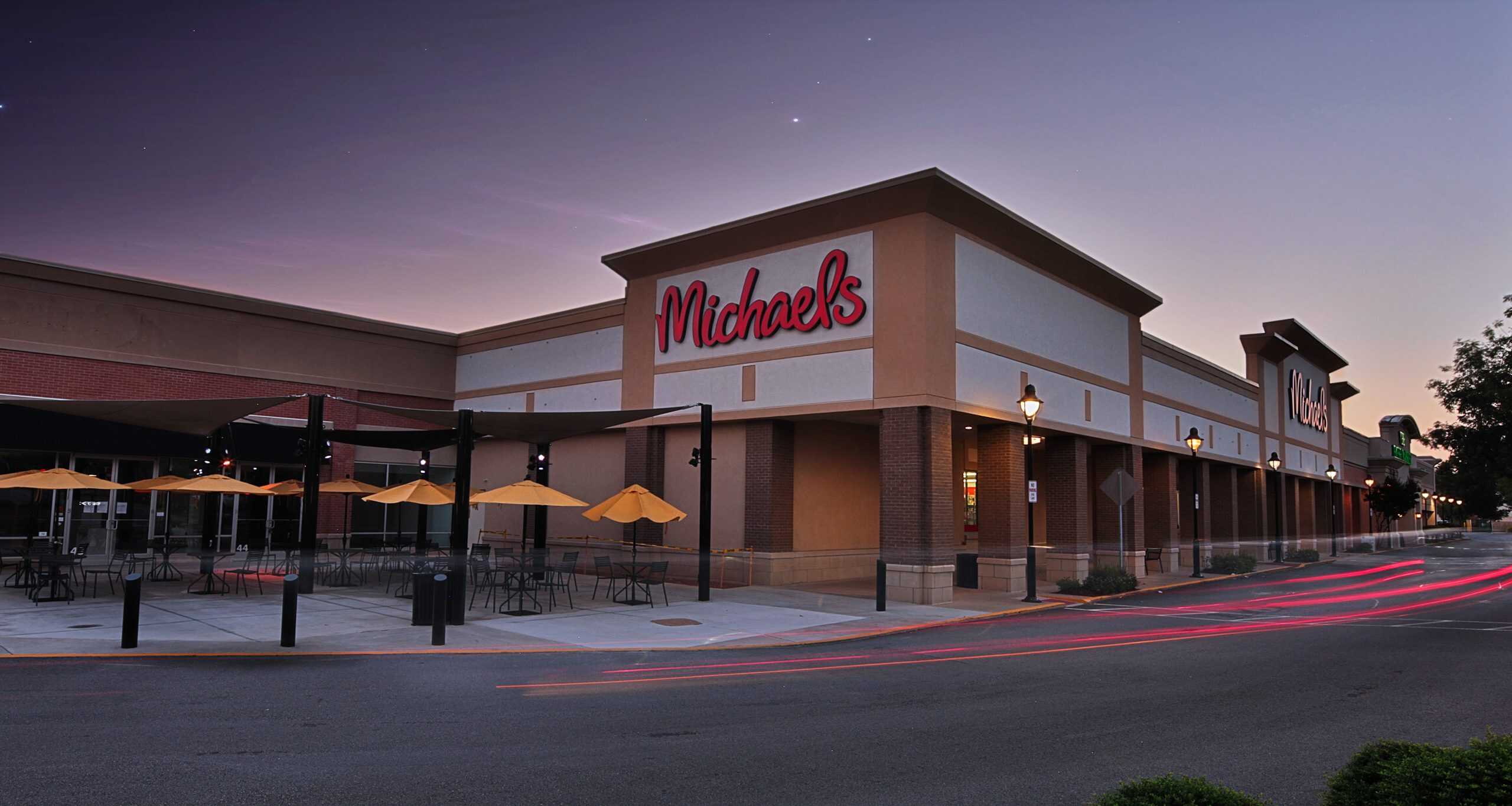 Michaels storefront at dusk in Athens, GA, with a covered sidewalk and neighboring shops.
