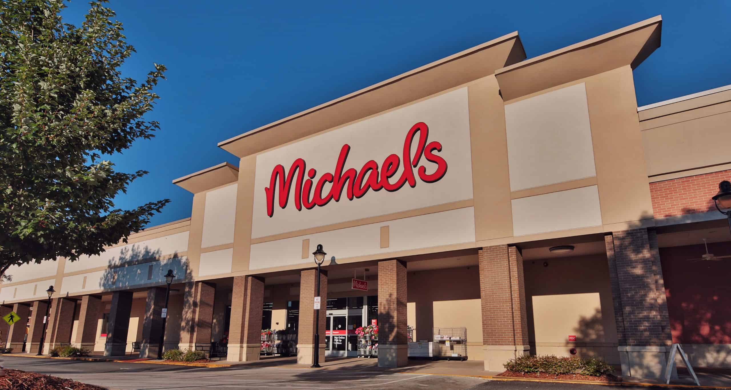 Michaels entrance beneath a large red sign and covered walkway in Athens, GA.